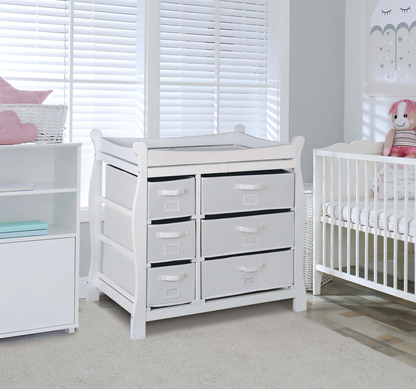 Sleigh Style Baby Changing Table with 6 Baskets -Lifestyle Image Inclined Side View of Sleigh Style Baby Changing Table with 6 Baskets Multi Tone White