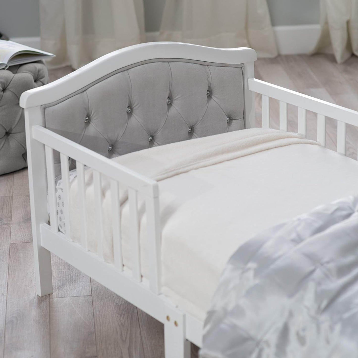 French White Padded Gray Toddler Bed - Zoomed Lifestyle Image Inclined Side View French White Padded Gray Toddler Bed
