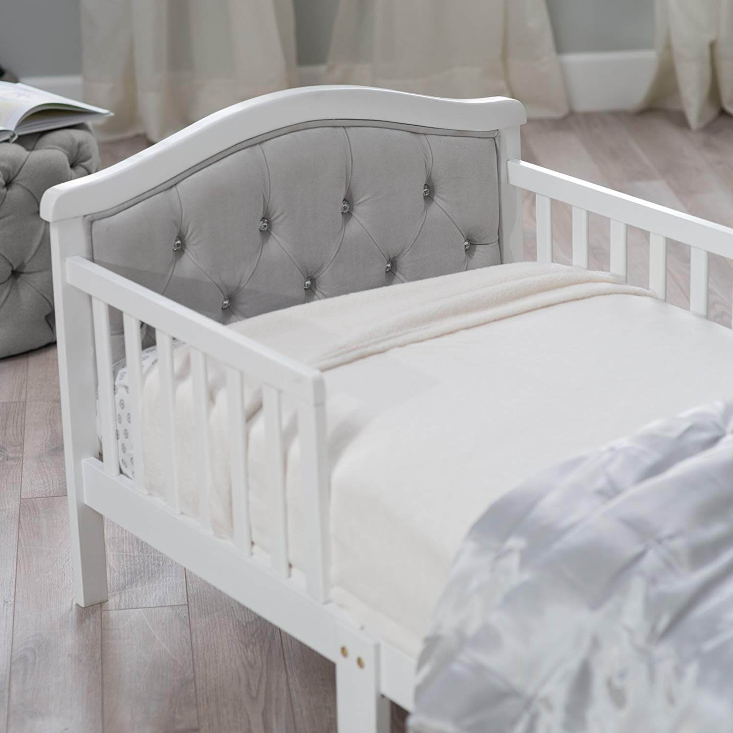 French White Padded Gray Toddler Bed - Zoomed Lifestyle Image Inclined Side View French White Padded Gray Toddler Bed