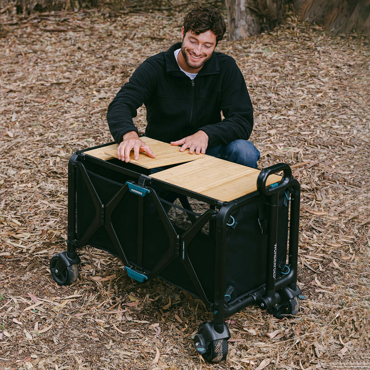 S5 Convertible Utility Wagon - Lifestyle Image of man Unfolding S5 Convertible Utility Wagon Black
