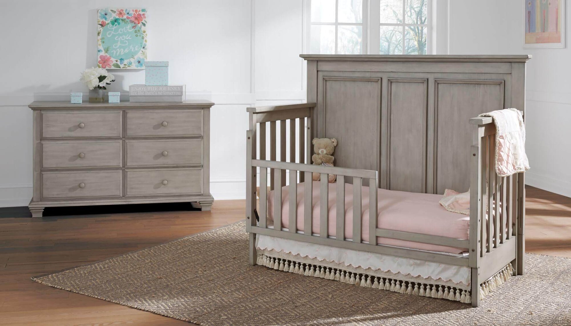 Kenilworth 4-in-1 Convertible Crib - Lifestyle Image Inclined Side View of Kenilworth 4-in-1 Convertible Crib Stone Wash with Guard Rail