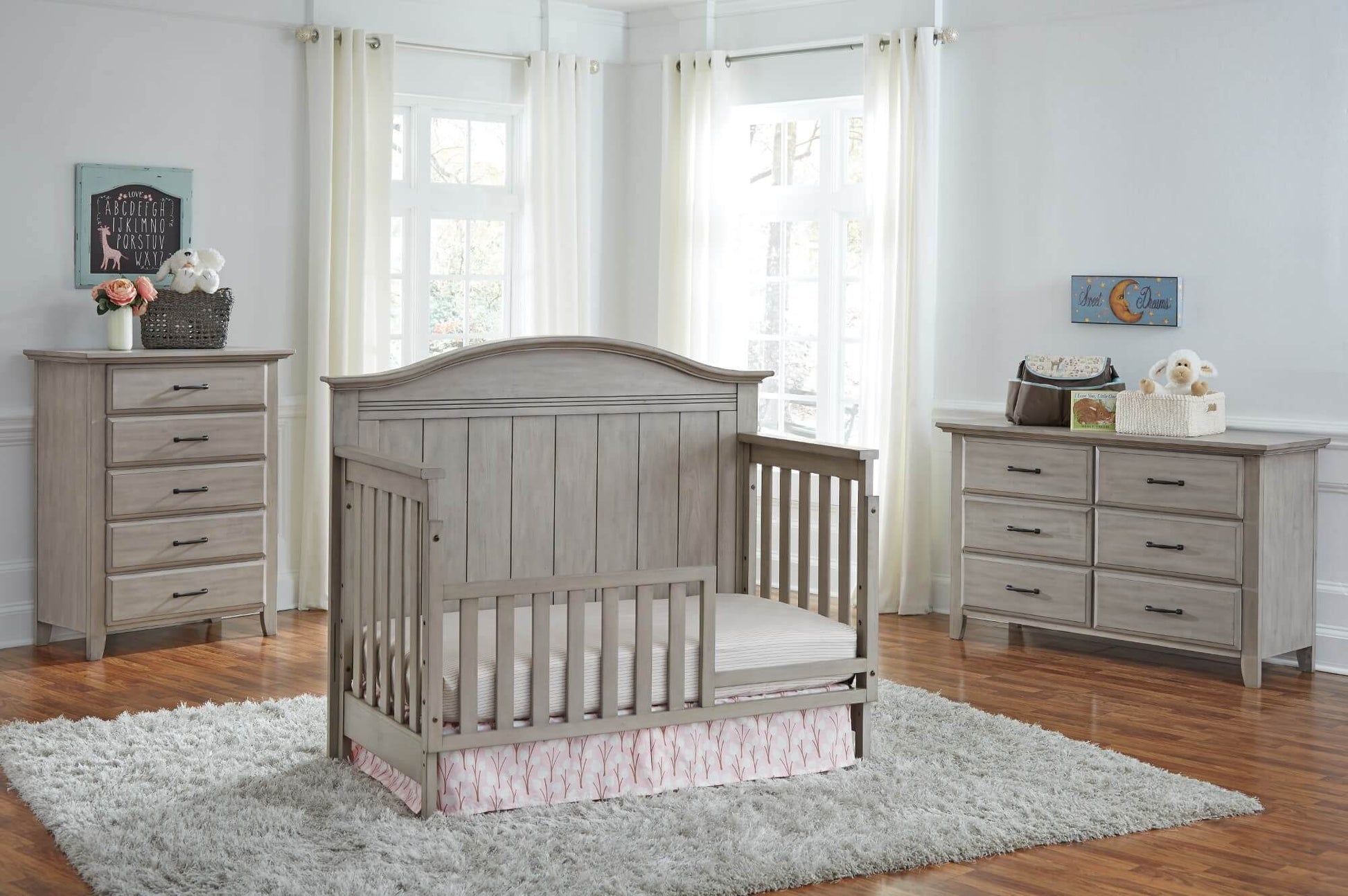 Chandler 4 In 1 Convertible Crib - Lifestyle Image Inclined Side View of Chandler 4 In 1 Convertible Crib Stone Wash with Guard Rail