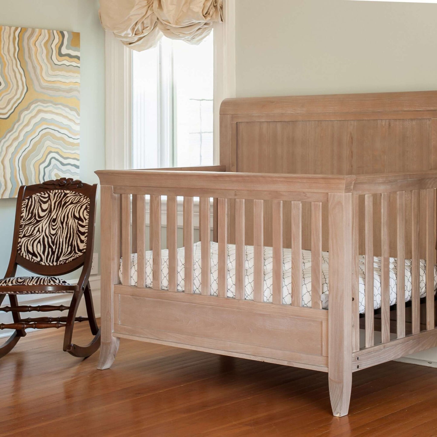 Cameo Sleigh 4-in-1 Convertible Crib - Lifestyle Image Side View of Sleigh 4-in-1 Convertible Crib Toast