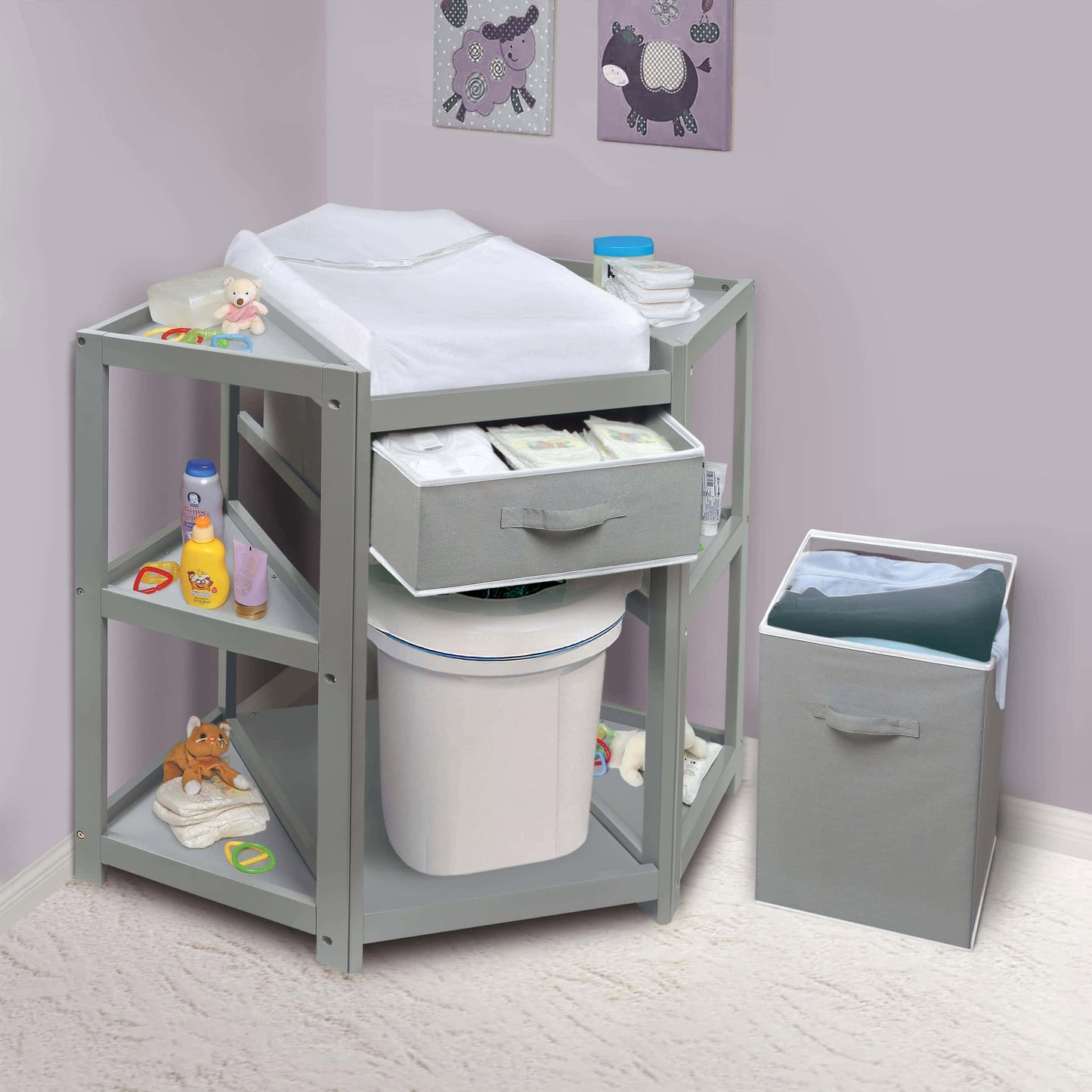 Diaper Corner Baby Changing Table with Hamper and Basket - Lifestyle Image Inclined Front View of Diaper Corner Baby Changing Table with Open Hamper and Out Basket Multi Tone Gray