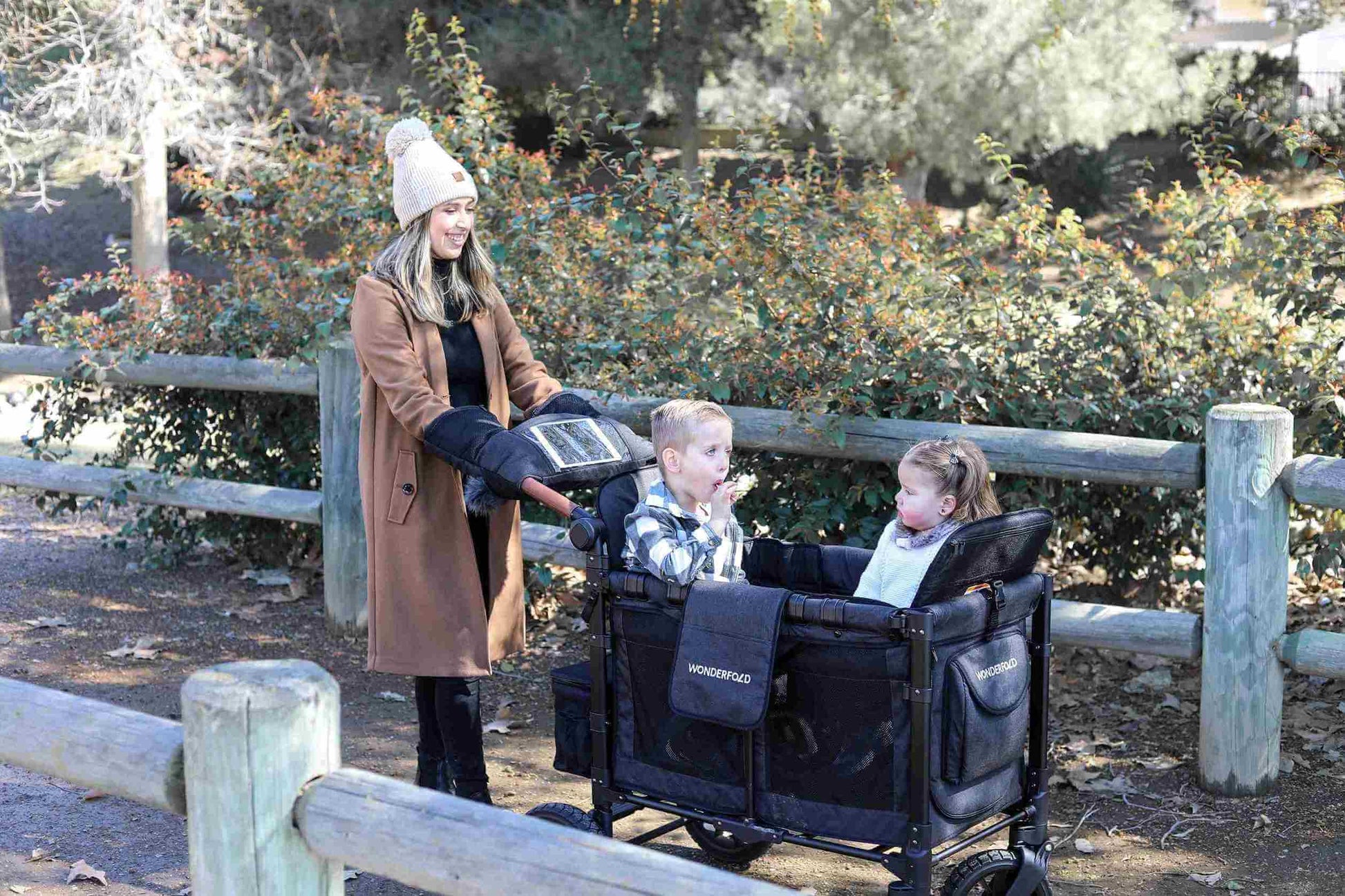 W2 Luxe Double Stroller Wagon - Lifestyle Image of Woman With Two Children on W2 Luxe Double Stroller Wagon Gray