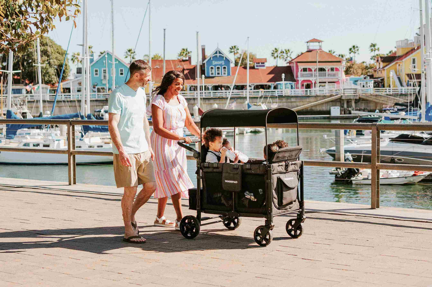 W4 Elite Quad Stroller Wagon - Lifestyle Image of Family Enjoying with Child on W4 Elite Quad Stroller Wagon Black