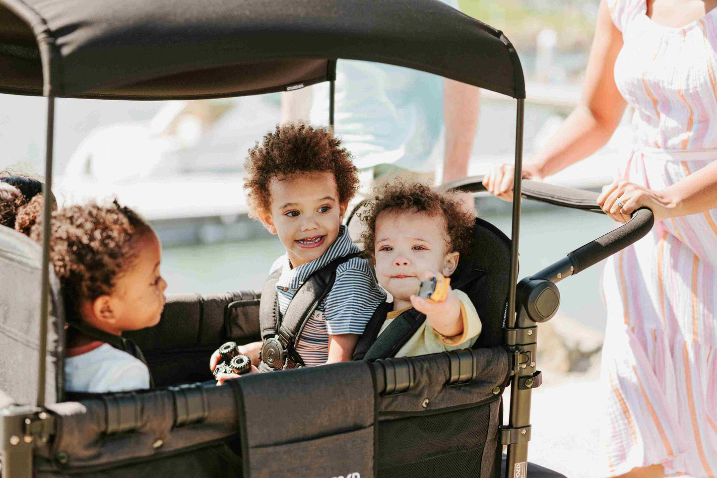 W4 Elite Quad Stroller Wagon - Lifestyle Image of Toddler's Enjoying on W4 Elite Quad Stroller Wagon Black
