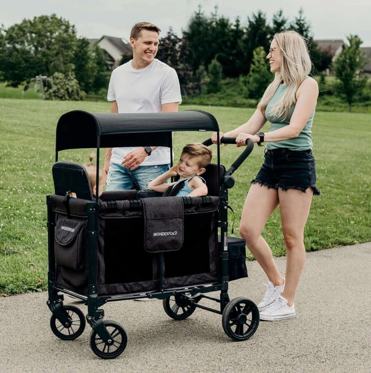 W4 Elite Quad Stroller Wagon - Lifestyle Image of Family Enjoying with Child on W4 Elite Quad Stroller Wagon Black