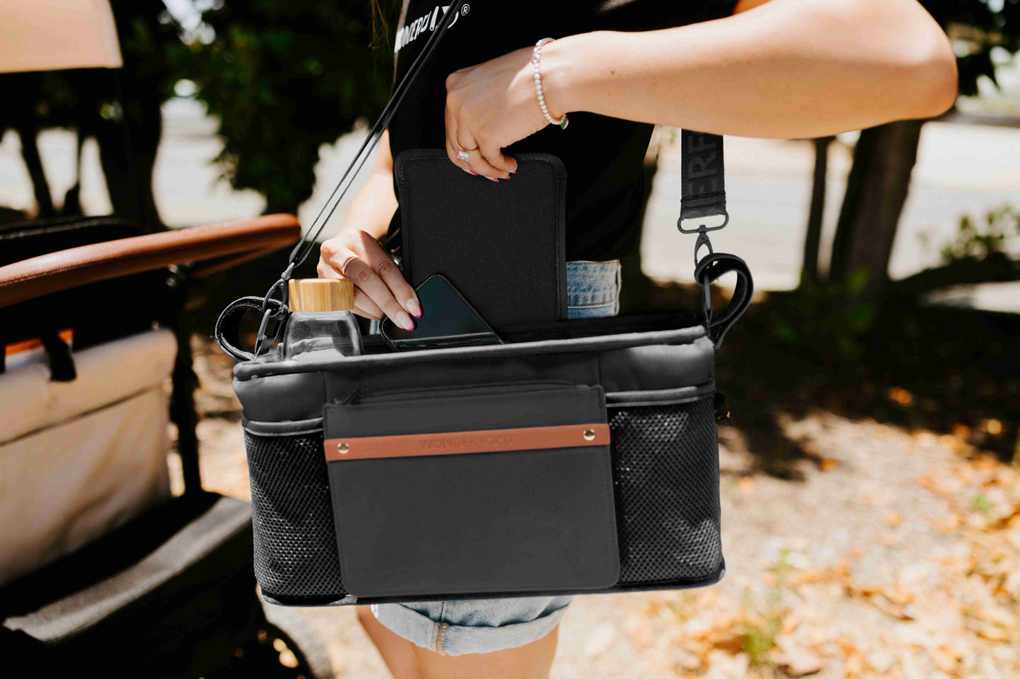 Parent Console with 2 Insulated Cup Holders - Lifestyle Image Zoom View of Women Holding Parent Console with 2 Insulated Cup Holders Black