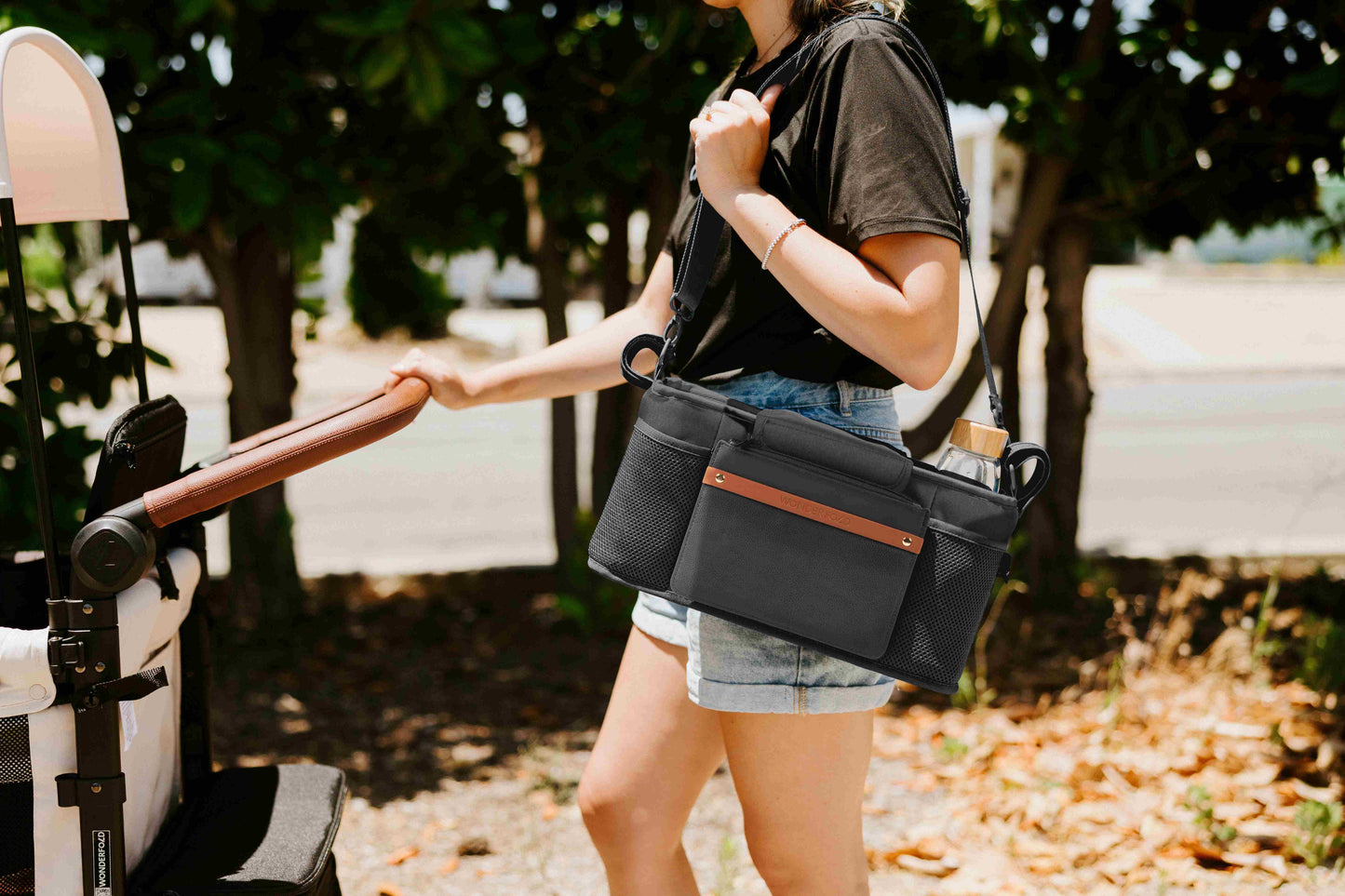 Parent Console with 2 Insulated Cup Holders - Lifestyle Image of Women Carrying Parent Console with 2 Cup Holders Black