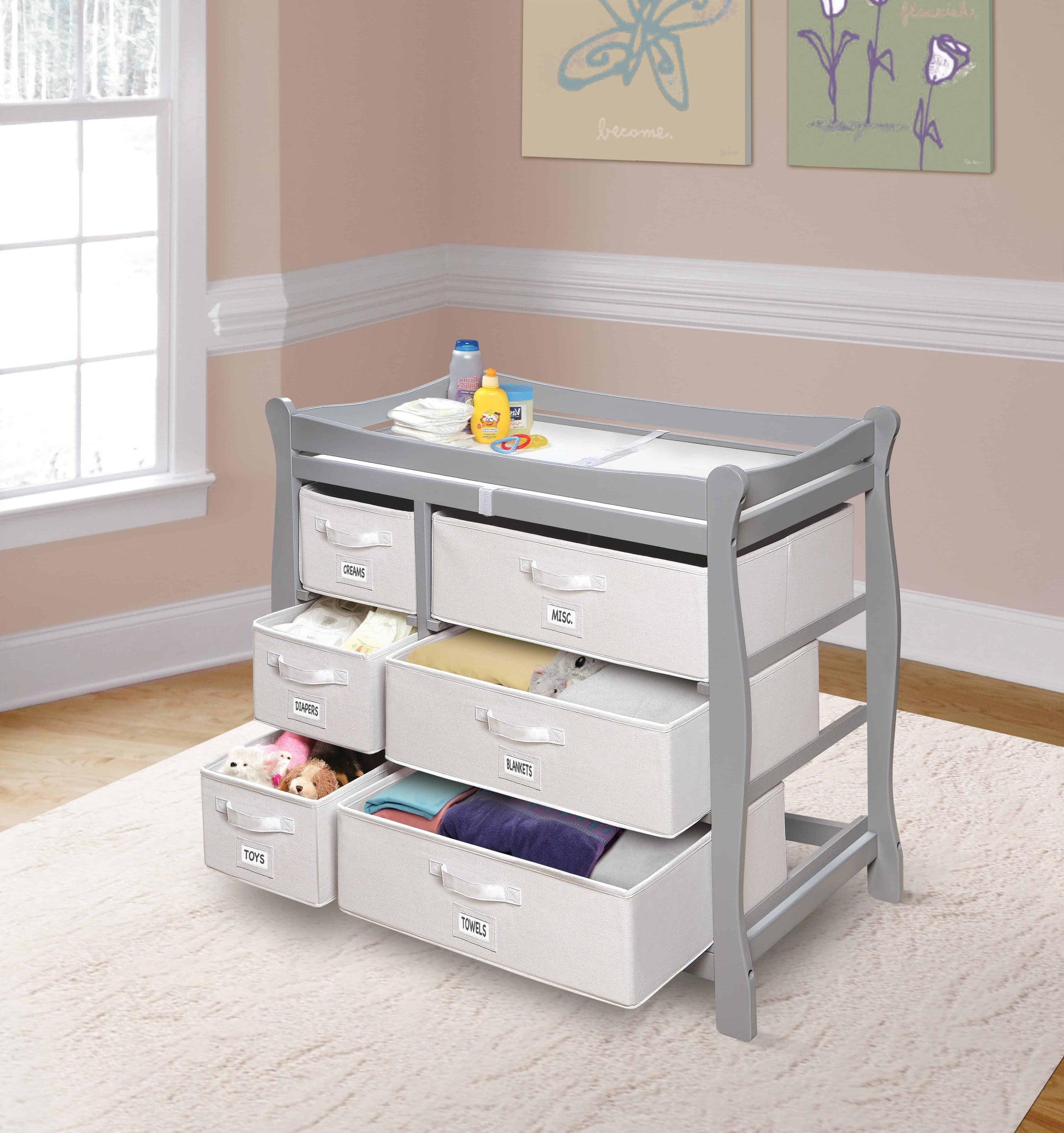 Sleigh Style Baby Changing Table with 6 Baskets -Lifestyle Image Inclined Side View of Sleigh Open Drawer Style Baby Changing Table with 6 Baskets Multi Tone Gray