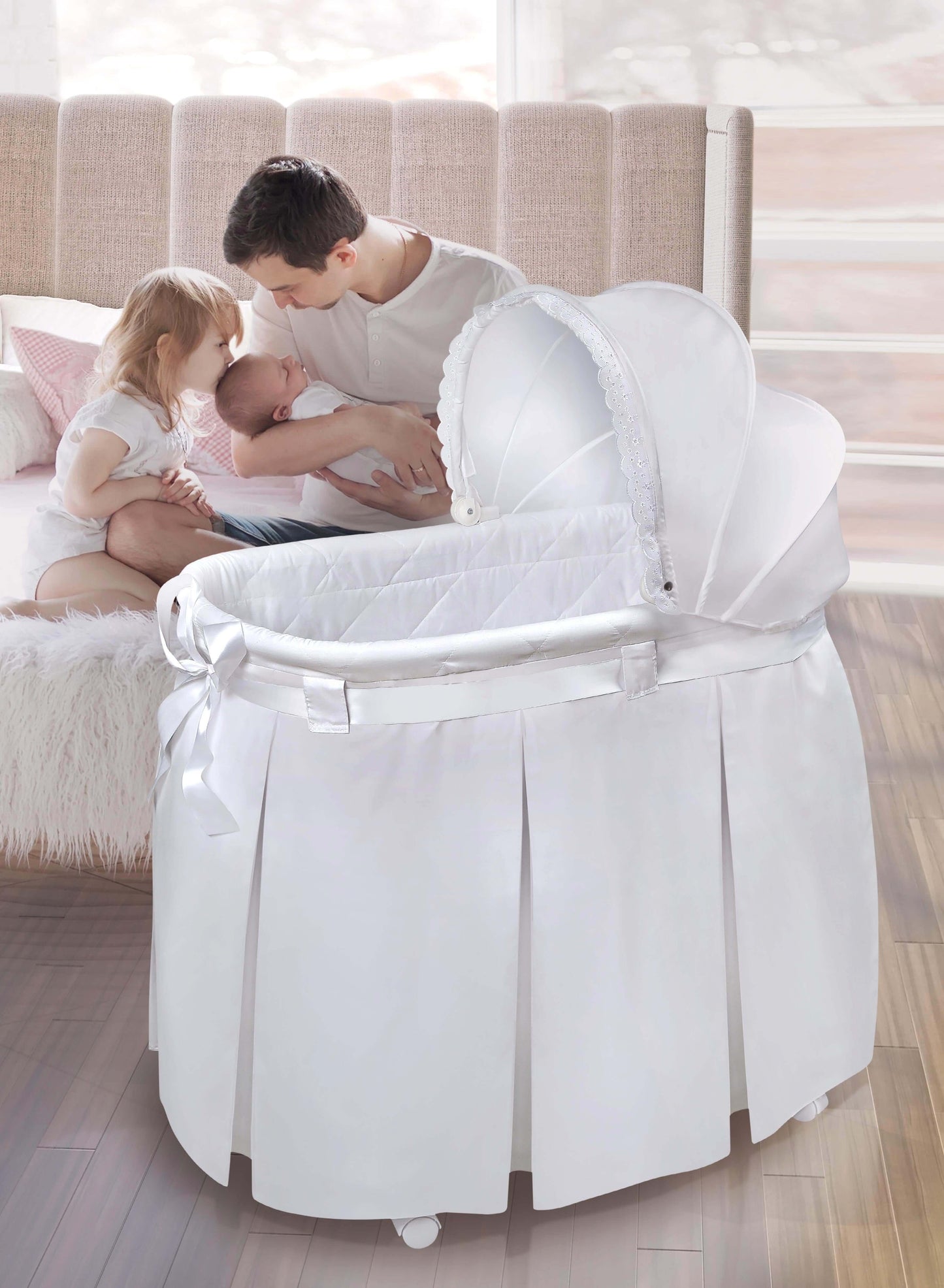 Wishes Oval Bassinet - Lifestyle Image of Mother Holding Baby Besides Wishes Oval Bassinet White Bedding