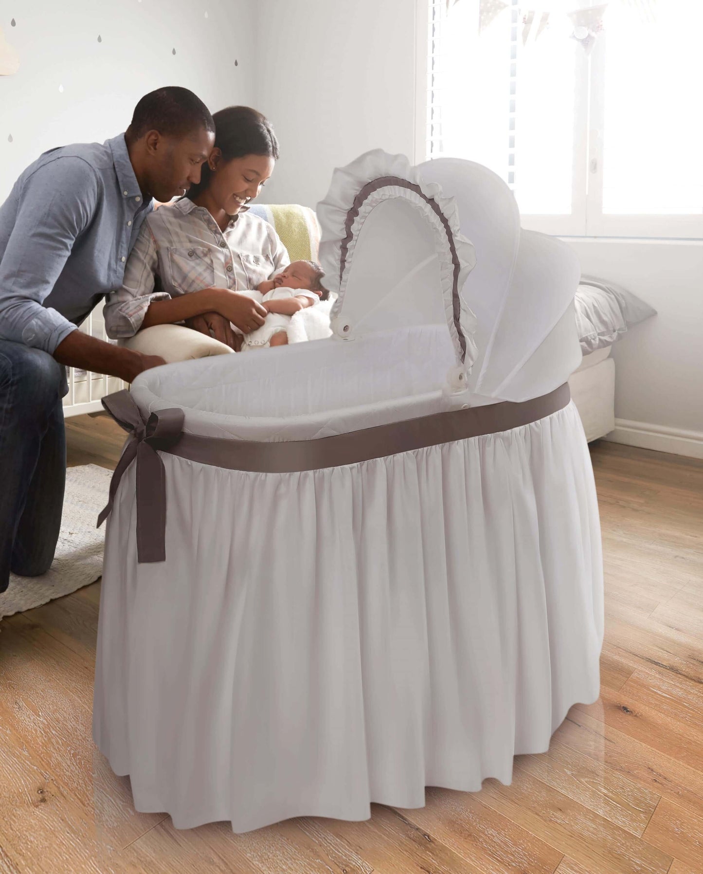 Wishes Oval Bassinet - Lifestyle Image of Parent Playing with there Baby Around Wishes Oval Bassinet White