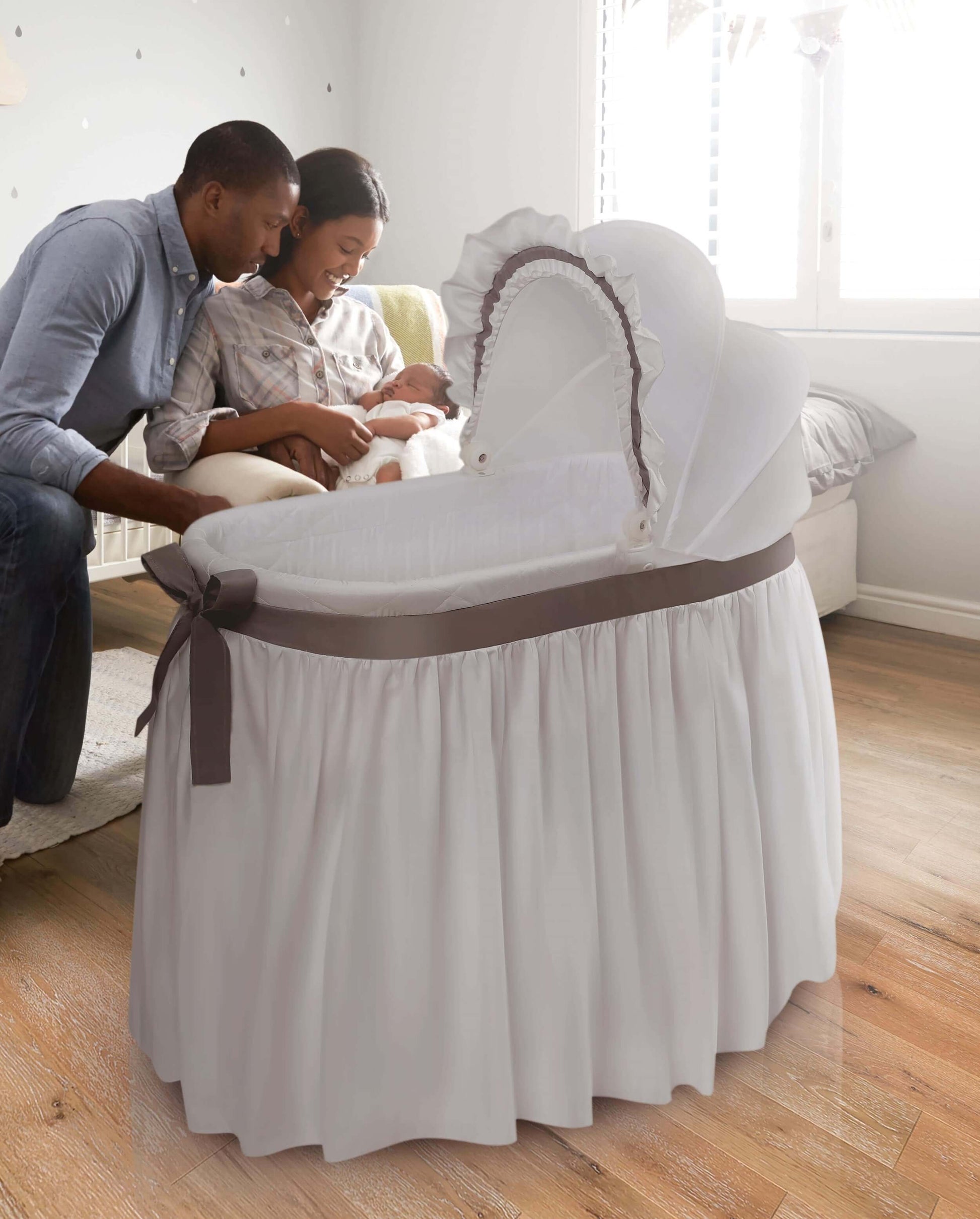 Wishes Oval Bassinet - Lifestyle Image of Parent Playing with there Baby Around Wishes Oval Bassinet White