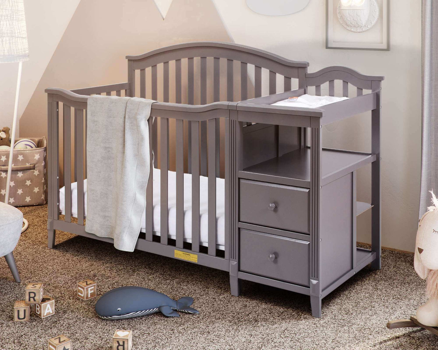 Kali 4-in-1 Crib and Changer - Lifestyle Image Inclined Side View of Kali 4-in-1 Crib and Changer Gray