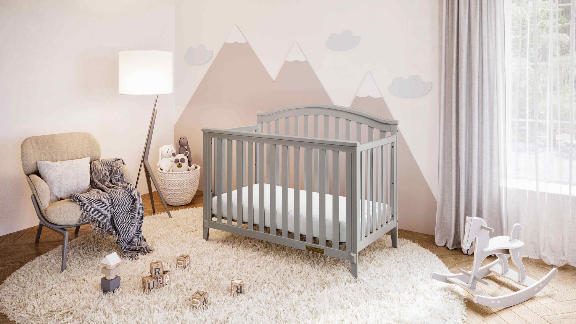 Kali II 4-in-1 Crib (Flat Footboard) - Full Lifestyle Image Inclined Side View of Kali II 4-in-1 Crib Gray