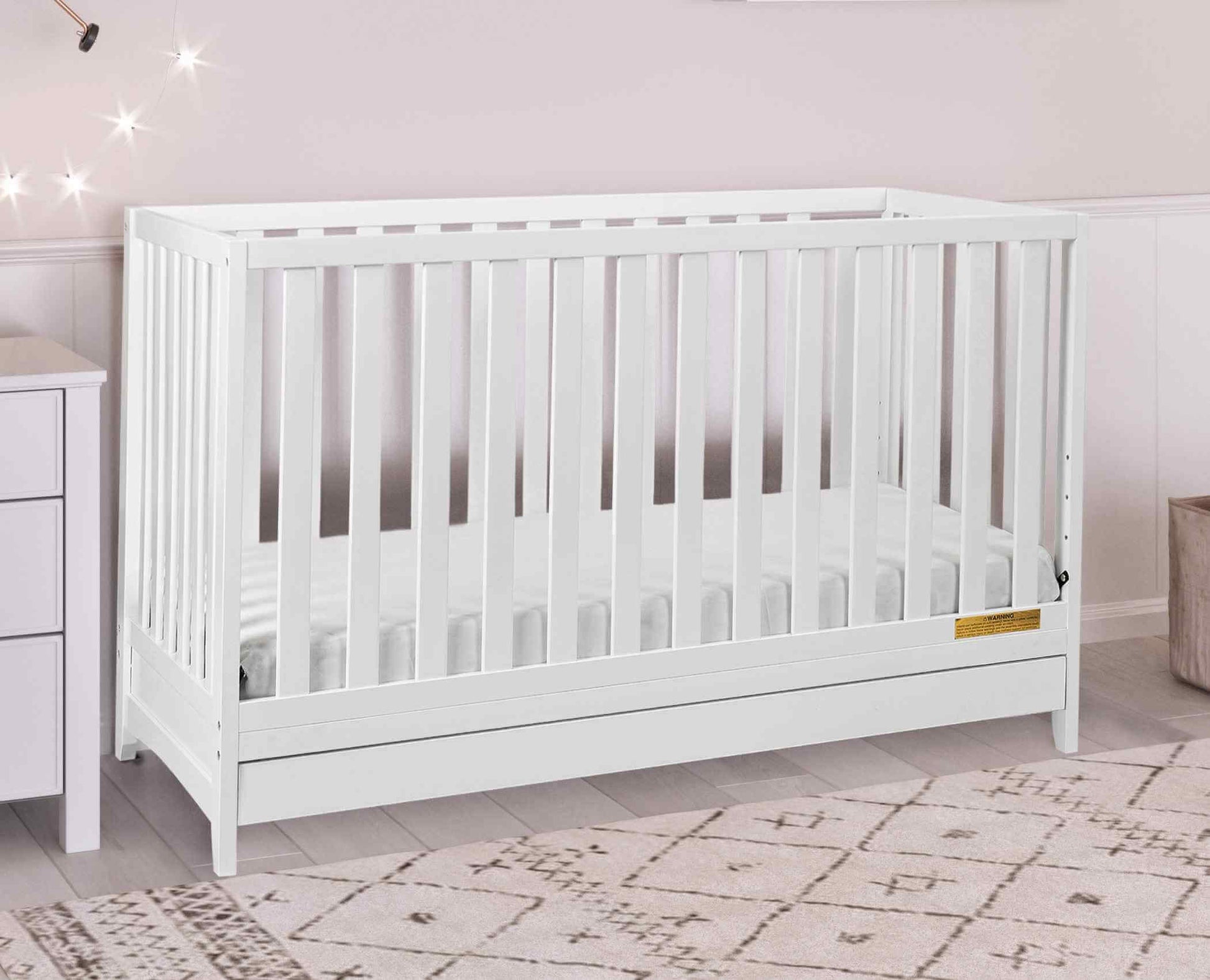 Mila 3-in-1 Convertible Crib with Drawer - Lifestyle Image Inclined Side View of Mila 3-in-1 Convertible Crib with Drawer White