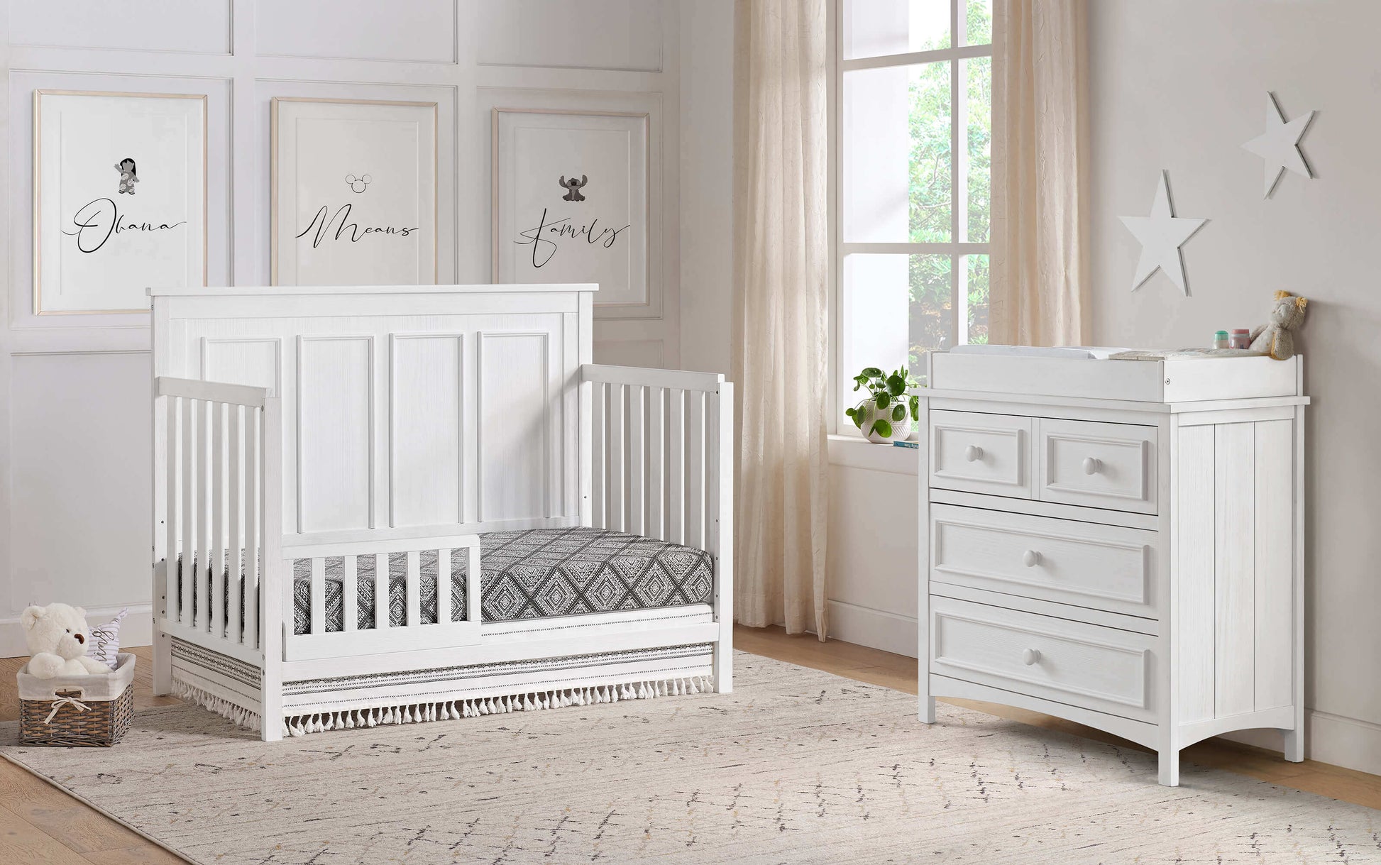 Bennett 4-in-1 Convertible Crib - Lifestyle Image Inclined Side View of Bennett 4-in-1 Convertible Crib Rustic White with Guard Rail