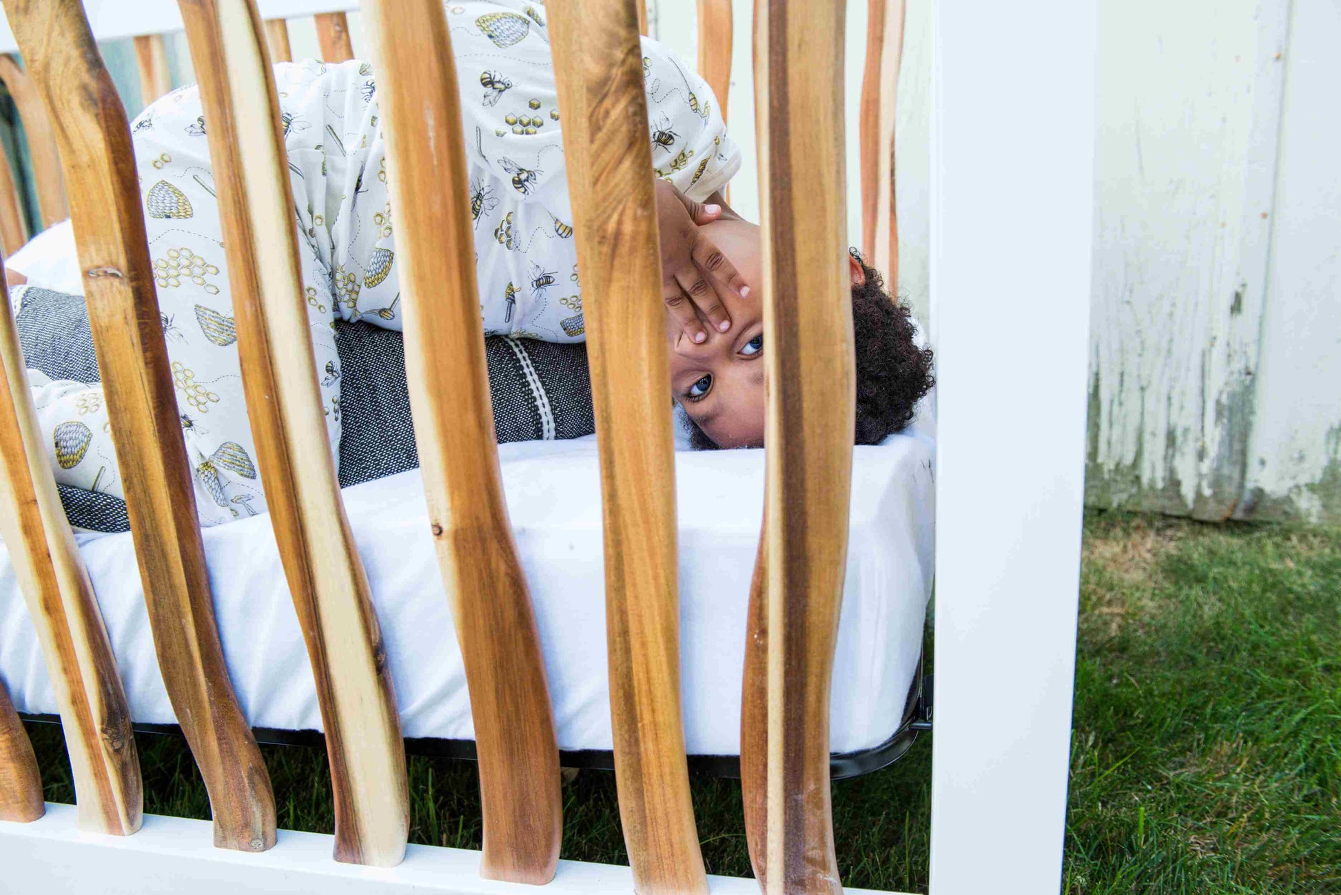 Branch 4 in 1 Convertible Crib - Zoomed Lifestyle Image of 4 in 1 Convertible Crib Acacia with Child Inside