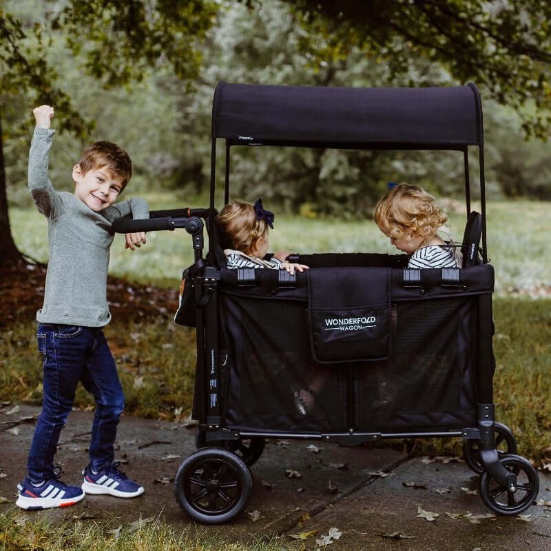 W2 Original + Double Stroller Wagon - Lifestyle Image of Teenager With Toddler on W2 Original + Double Stroller Wagon Black