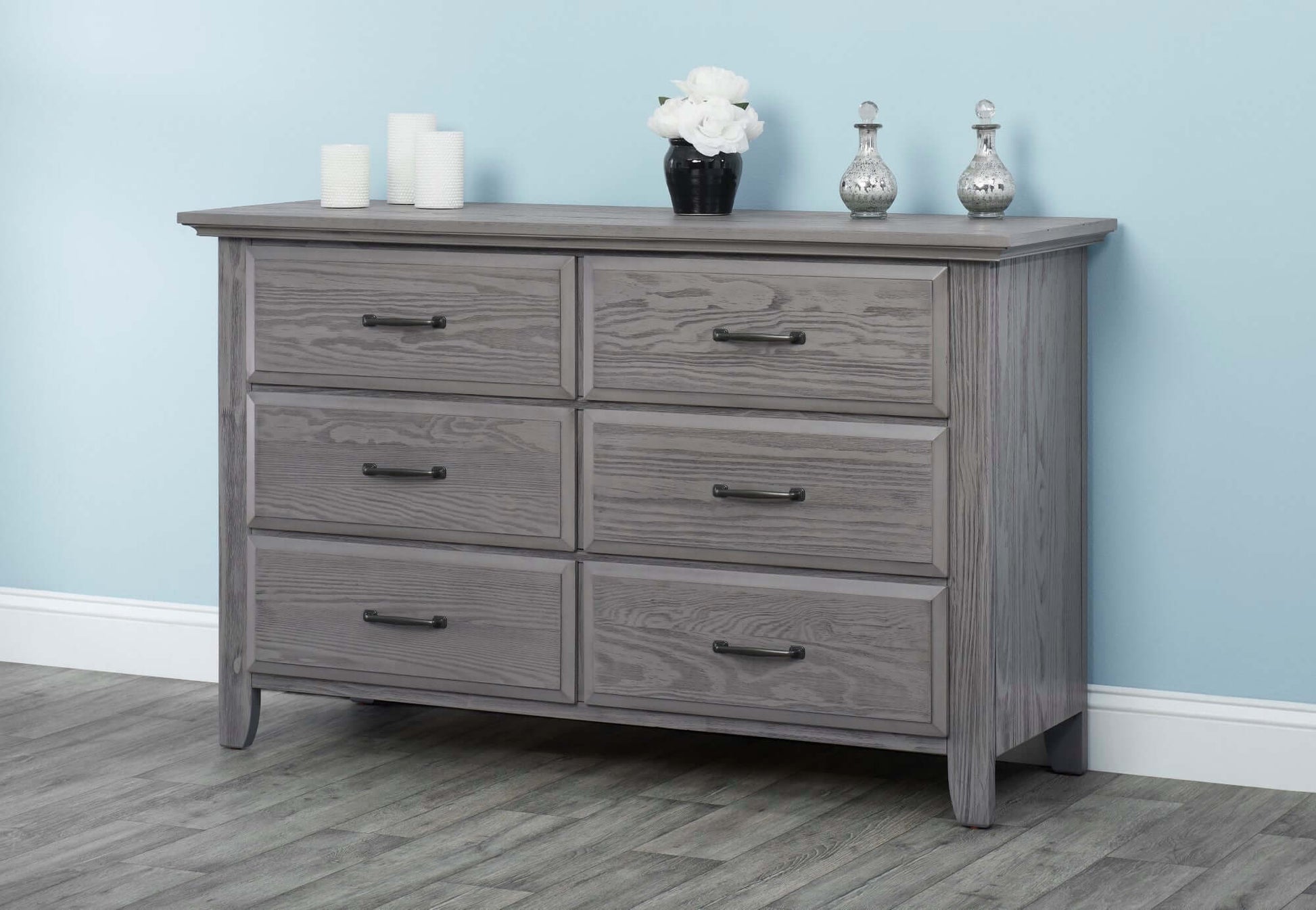 Chandler Changing Topper - Lifestyle Image Front View of Chandler Changing Topper Gray on Top of 6 Drawer Dresser