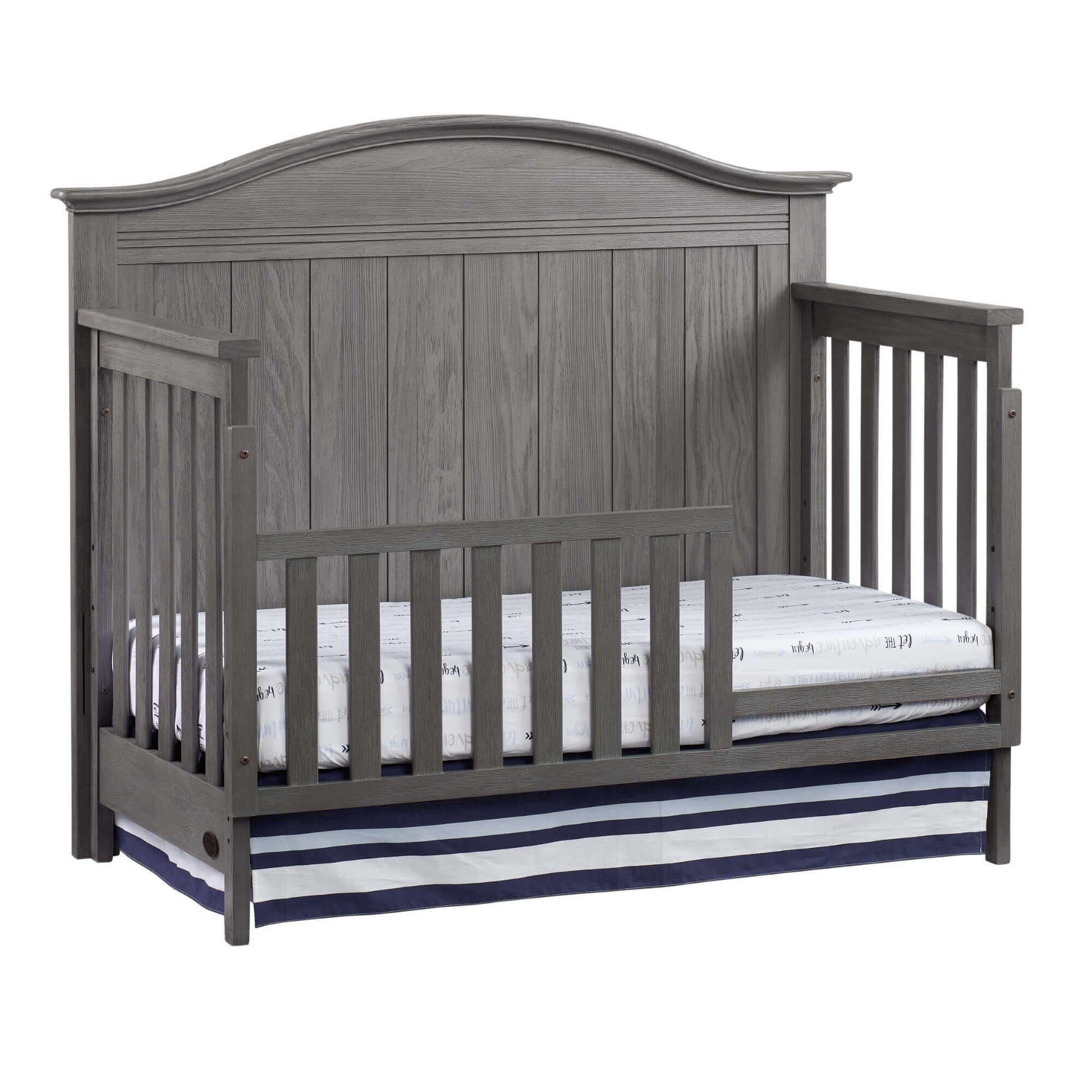Chandler 4 In 1 Convertible Crib - Inclined Side View of Chandler 4 In 1 Convertible Crib Graphite Gray with Guard Rail