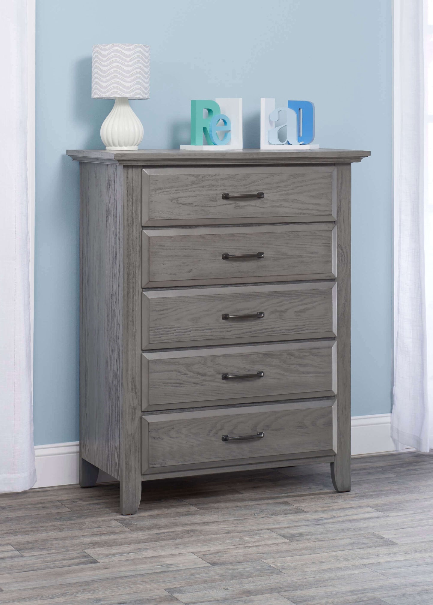 Chandler 5 Drawer Chest - Lifestyle Image Inclined Side View of Chandler 5 Drawer Chest Rustic Gray