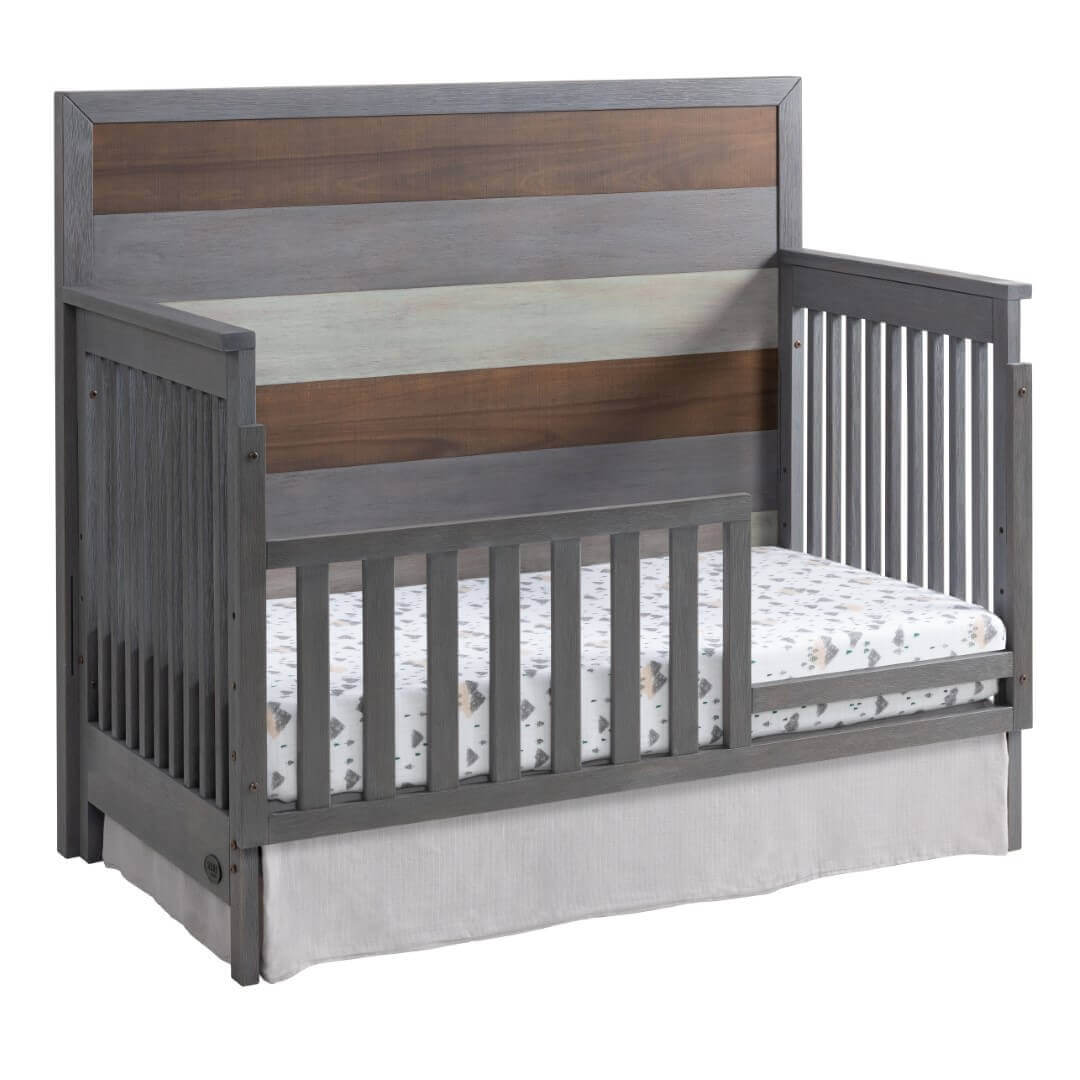 Cascade 4 In 1 Convertible Crib - Inclined Side View of Cascade 4 In 1 Convertible Crib Multi Tone Gray with Guard Rail