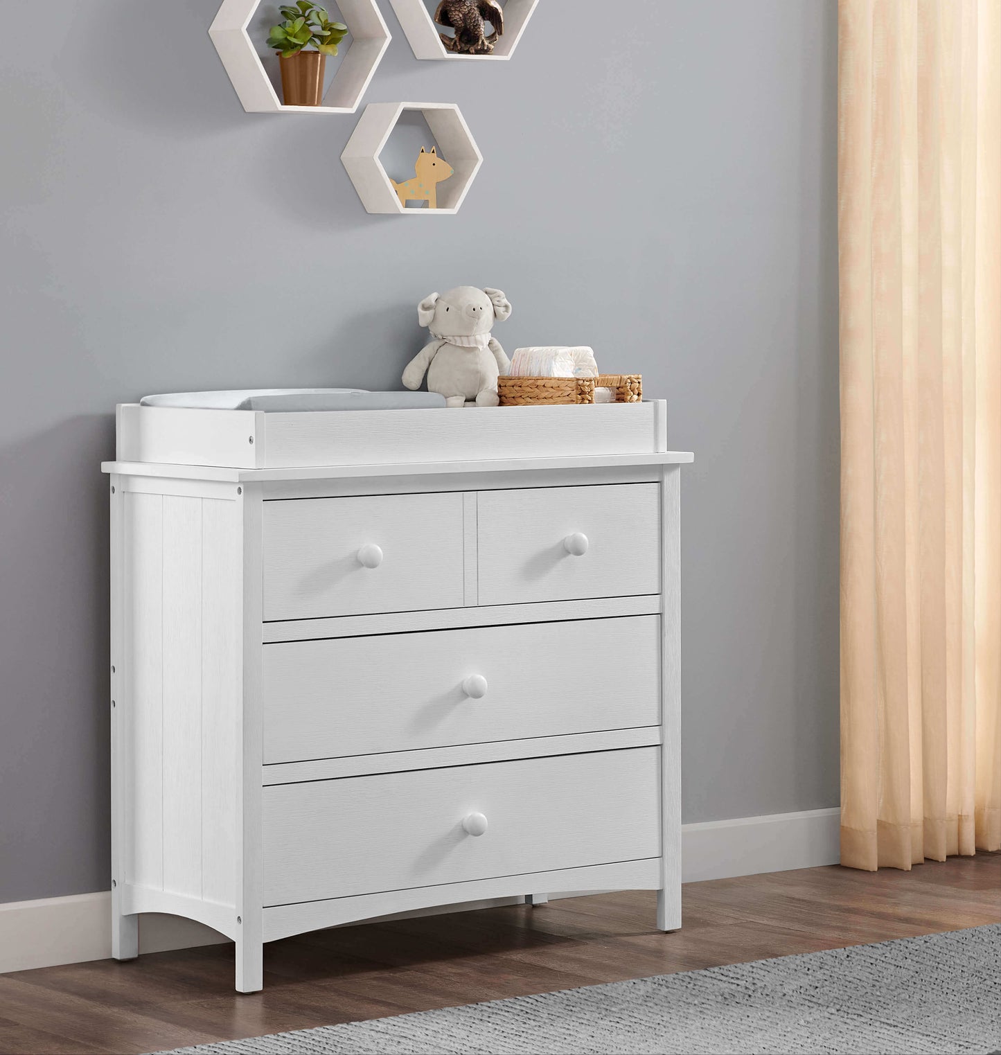 Castle Hill Changing Topper - Lifestyle Image Inclined Front View of Castle Hill Changing Topper White on top of Double Drawer Dresser