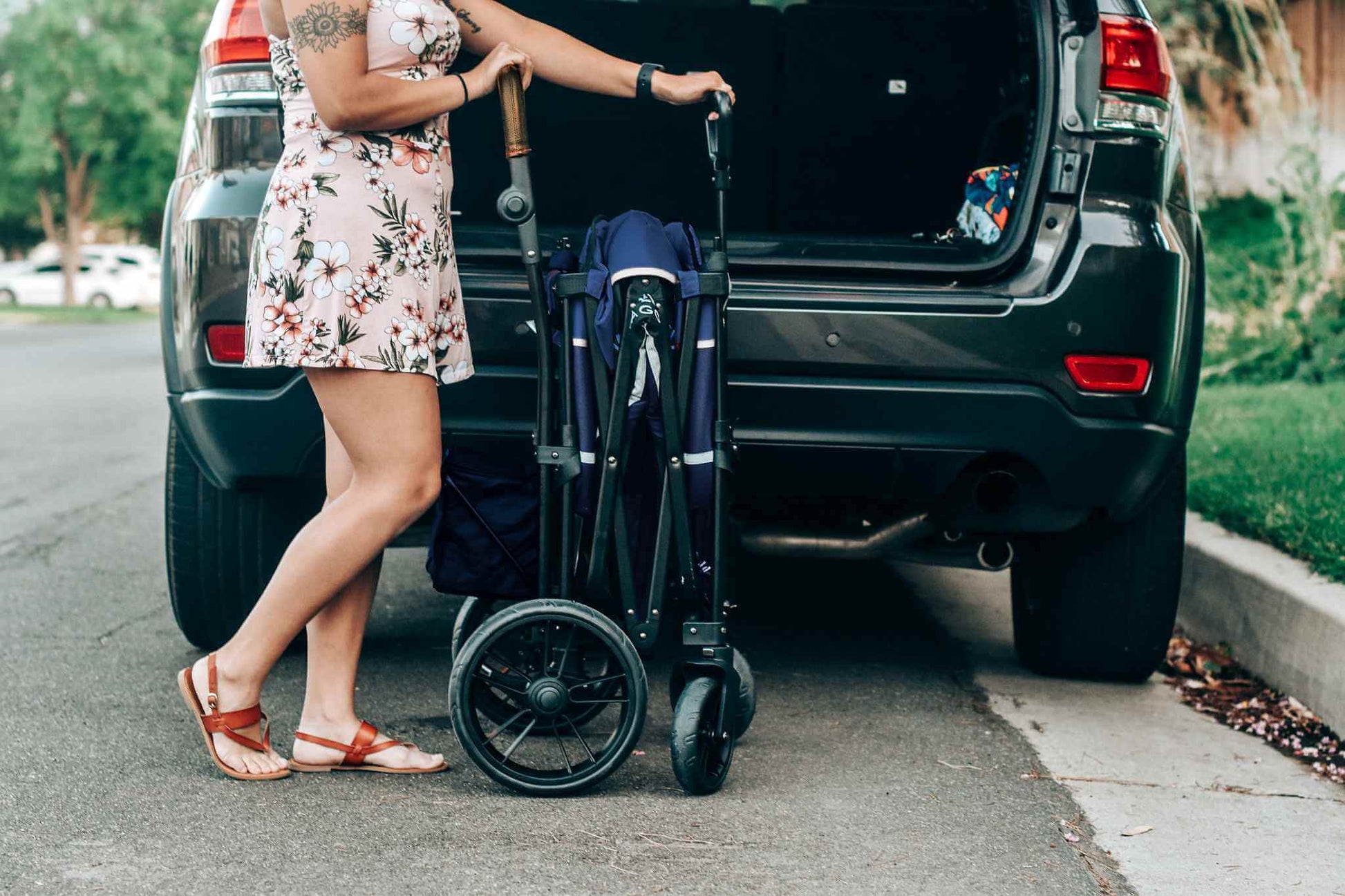 X2 Double Stroller Wagon - Lifestyle Image of Woman with Folded X2 Double Stroller Wagon Navy