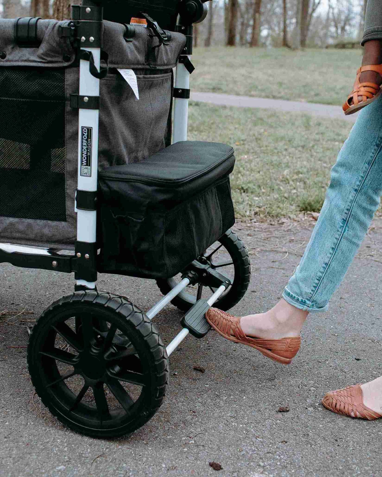 W4 Luxe Quad Stroller Wagon - Lifestyle Image Zoomed View of Brake Usage of W4 Luxe Quad Stroller Wagon Black Camo