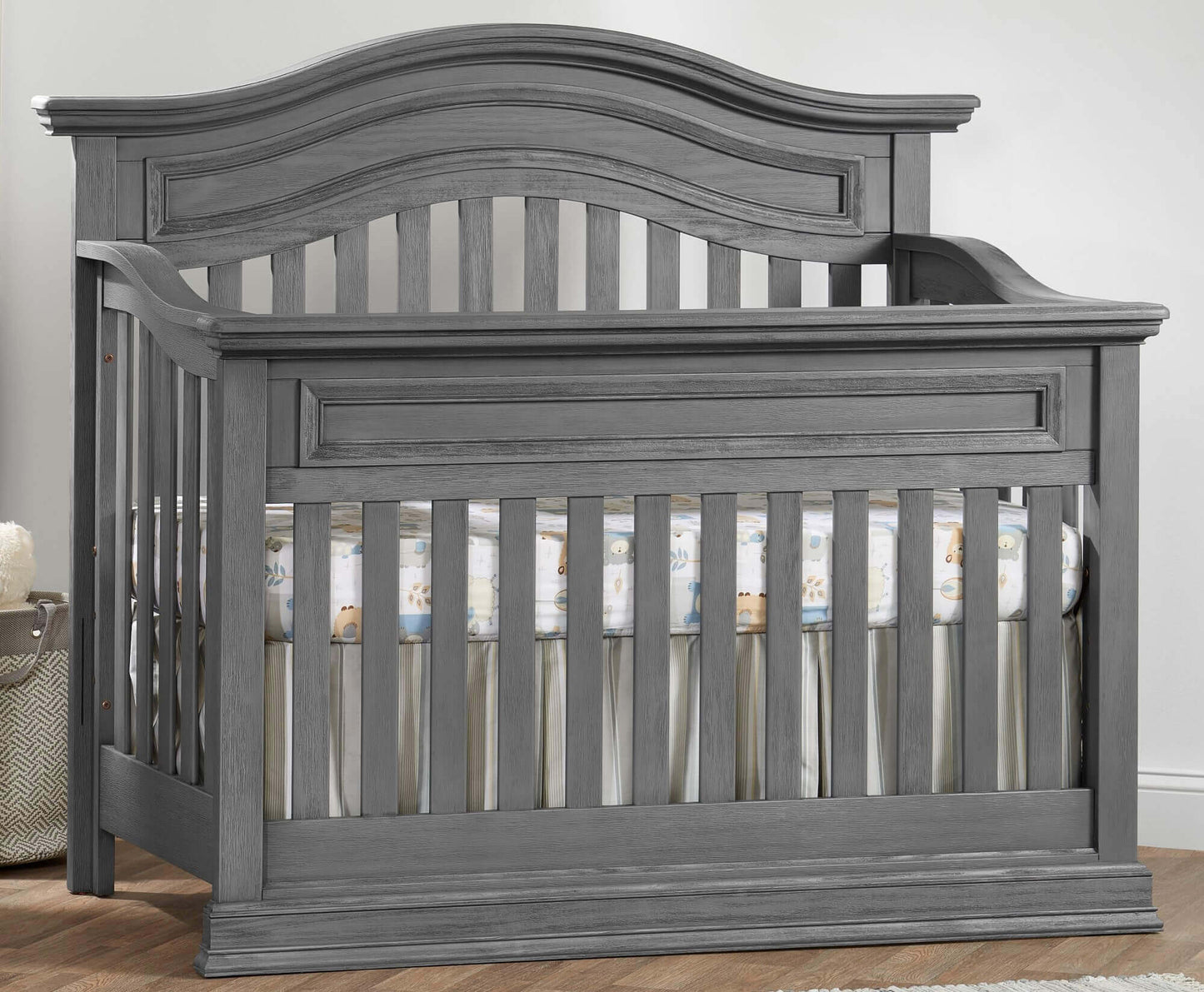 Glenbrook 4-in-1 Convertible Crib - Lifestyle Image Inclined Side View of Glenbrook 4-in-1 Convertible Crib Graphite Gray
