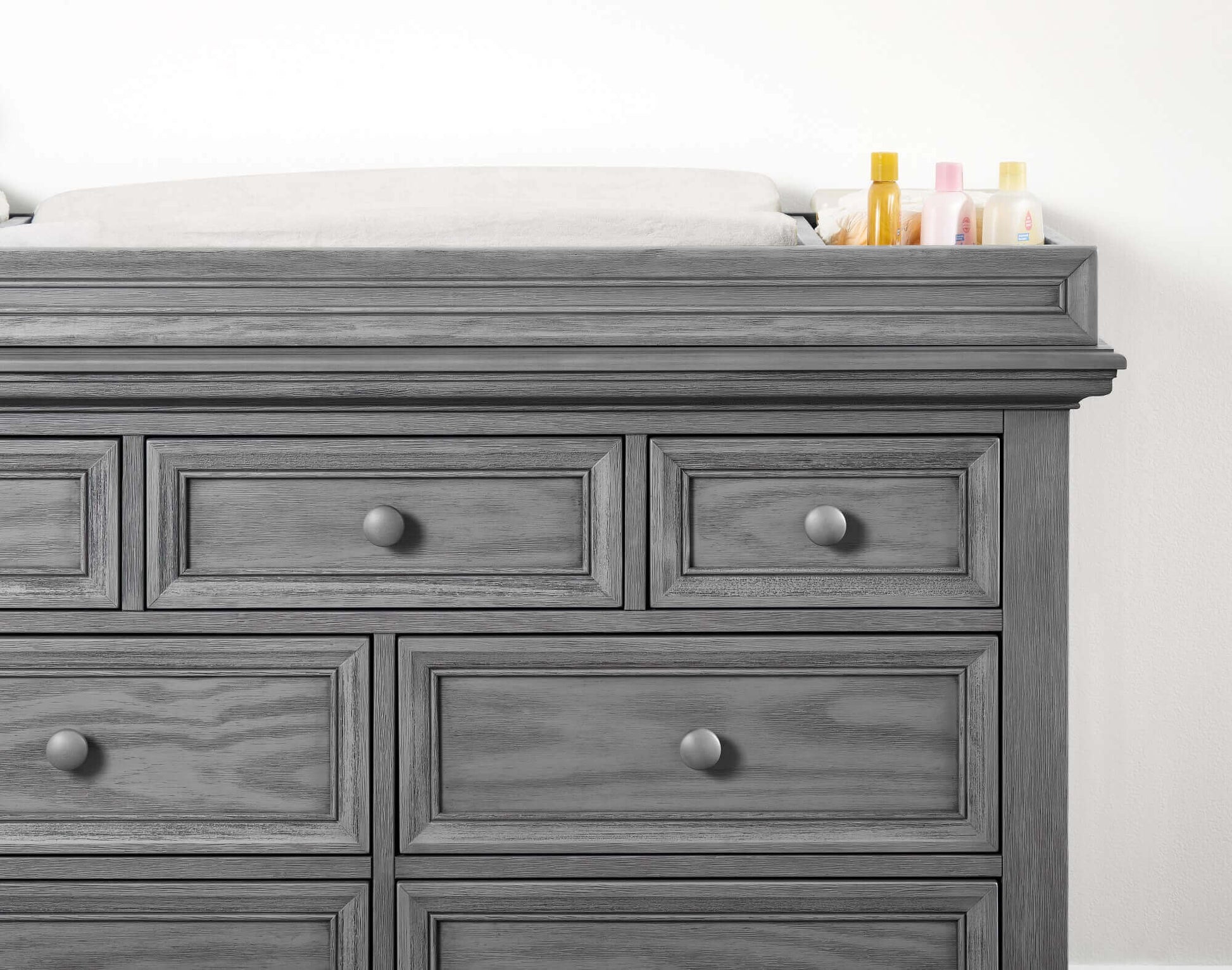 Glenbrook Changing Topper - Zoomed Front View of Glenbrook Changing Topper Gray on Top of Double Drawer Dresser