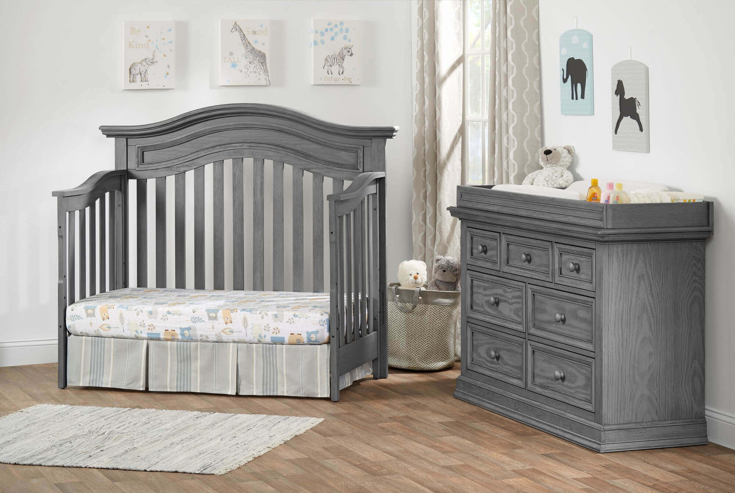 Glenbrook 4-in-1 Convertible Crib - Lifestyle Image Inclined Side View of Glenbrook Daybed Graphite Gray with 7 Drawer Dresser