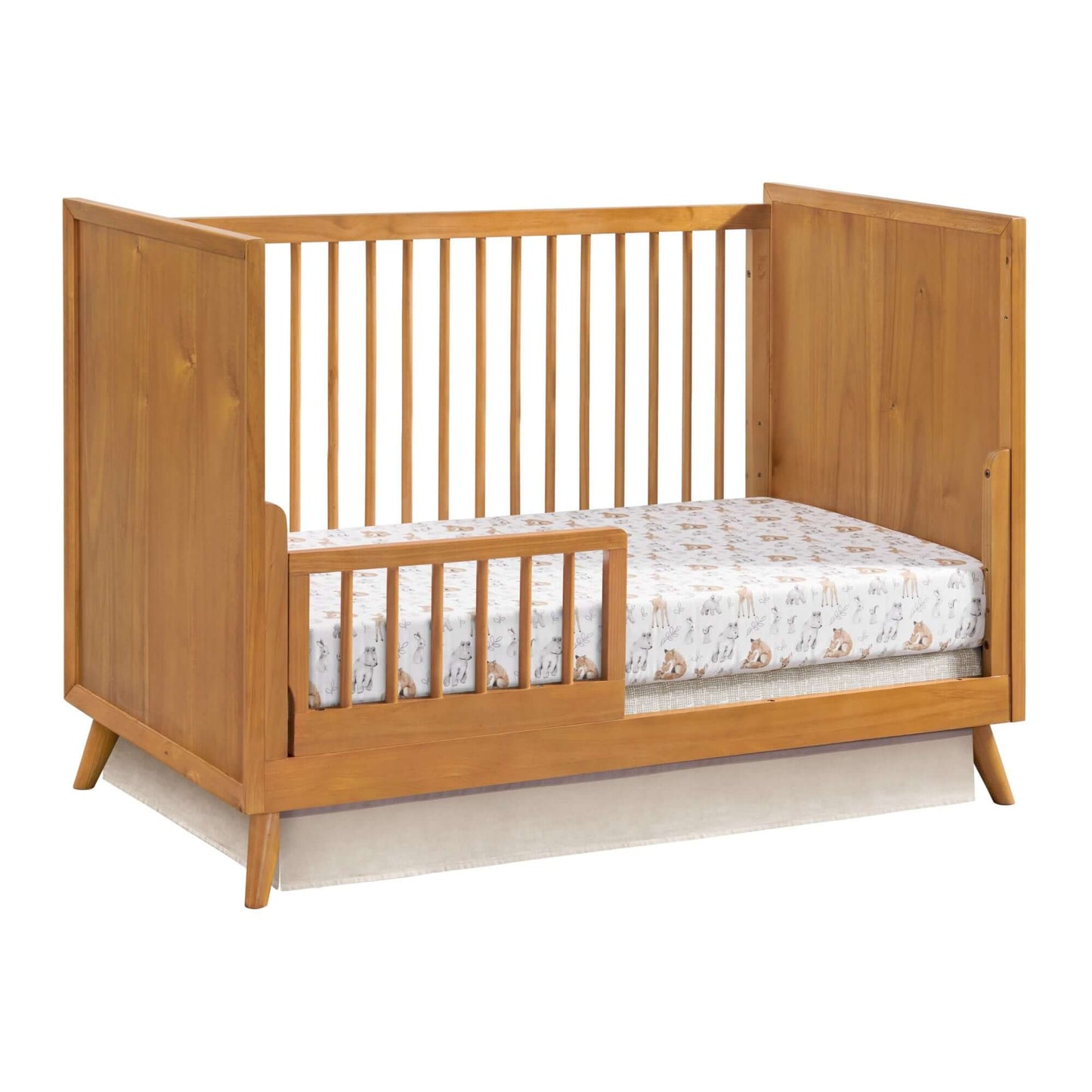 Dawson 3 In 1 Convertible Crib - Inclined Side View of Dawson 3 In 1 Convertible Crib Honey Brown with Guard Rail on Left