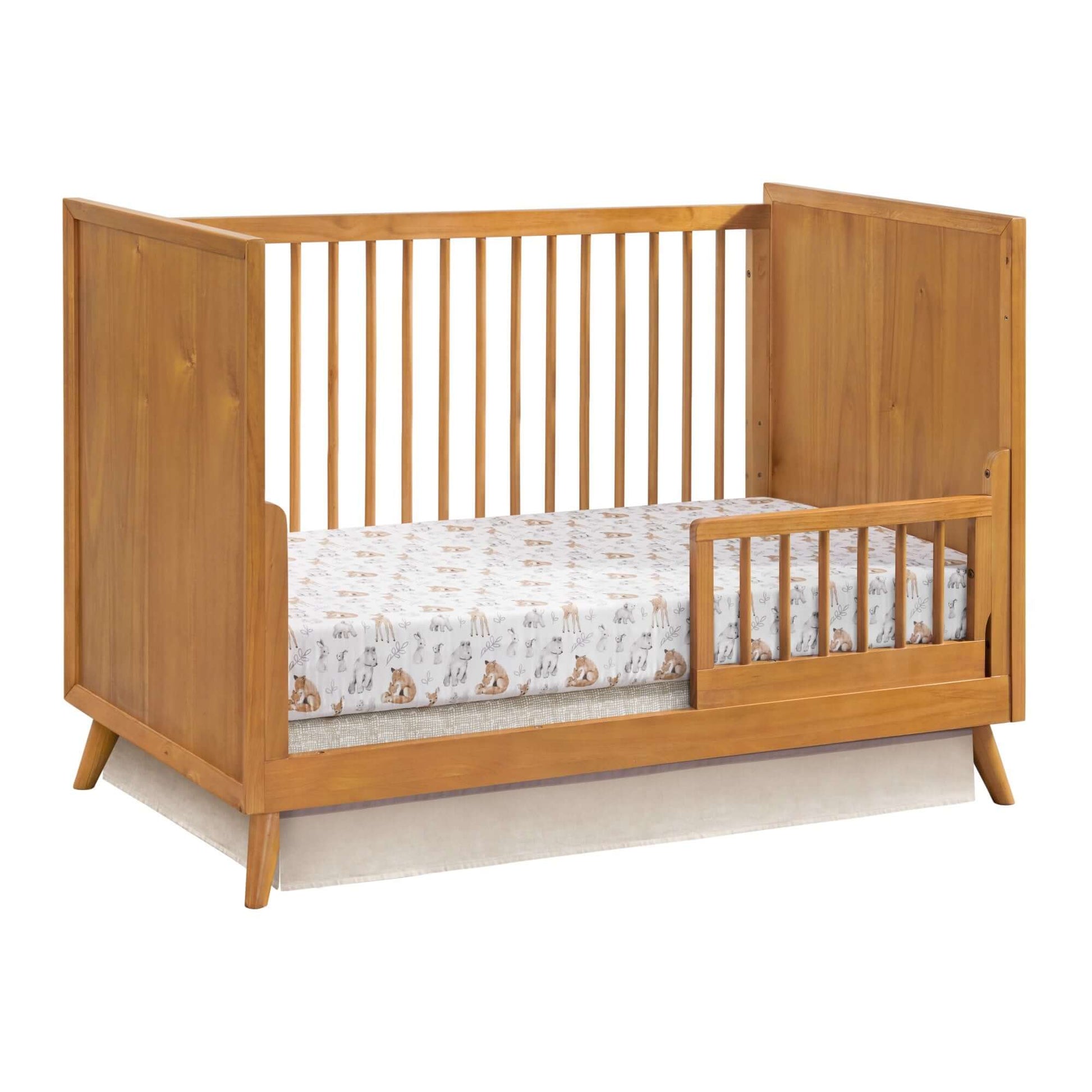 Dawson 3 In 1 Convertible Crib - Inclined Side View of Dawson 3 In 1 Convertible Crib Honey Brown with Guard Rail on Right