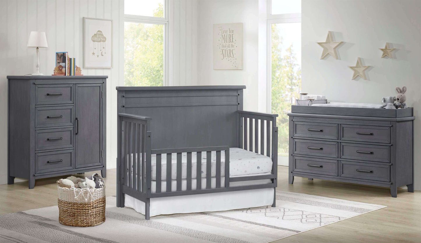 Ellison 4 In 1 Convertible Crib - Lifestyle Image Inclined Side View of Ellison 4 In 1 Convertible Crib Ash Gray with Guard Rail
