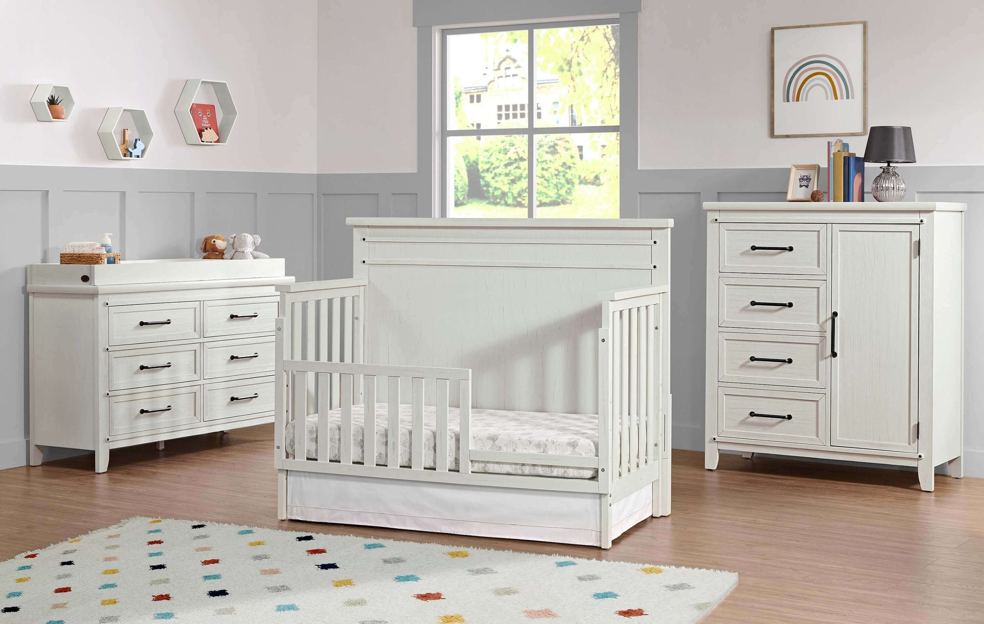 Ellison 4 In 1 Convertible Crib - Lifestyle Image Inclined Side View of Ellison 4 In 1 Convertible Crib Rustic White with Guard Rail