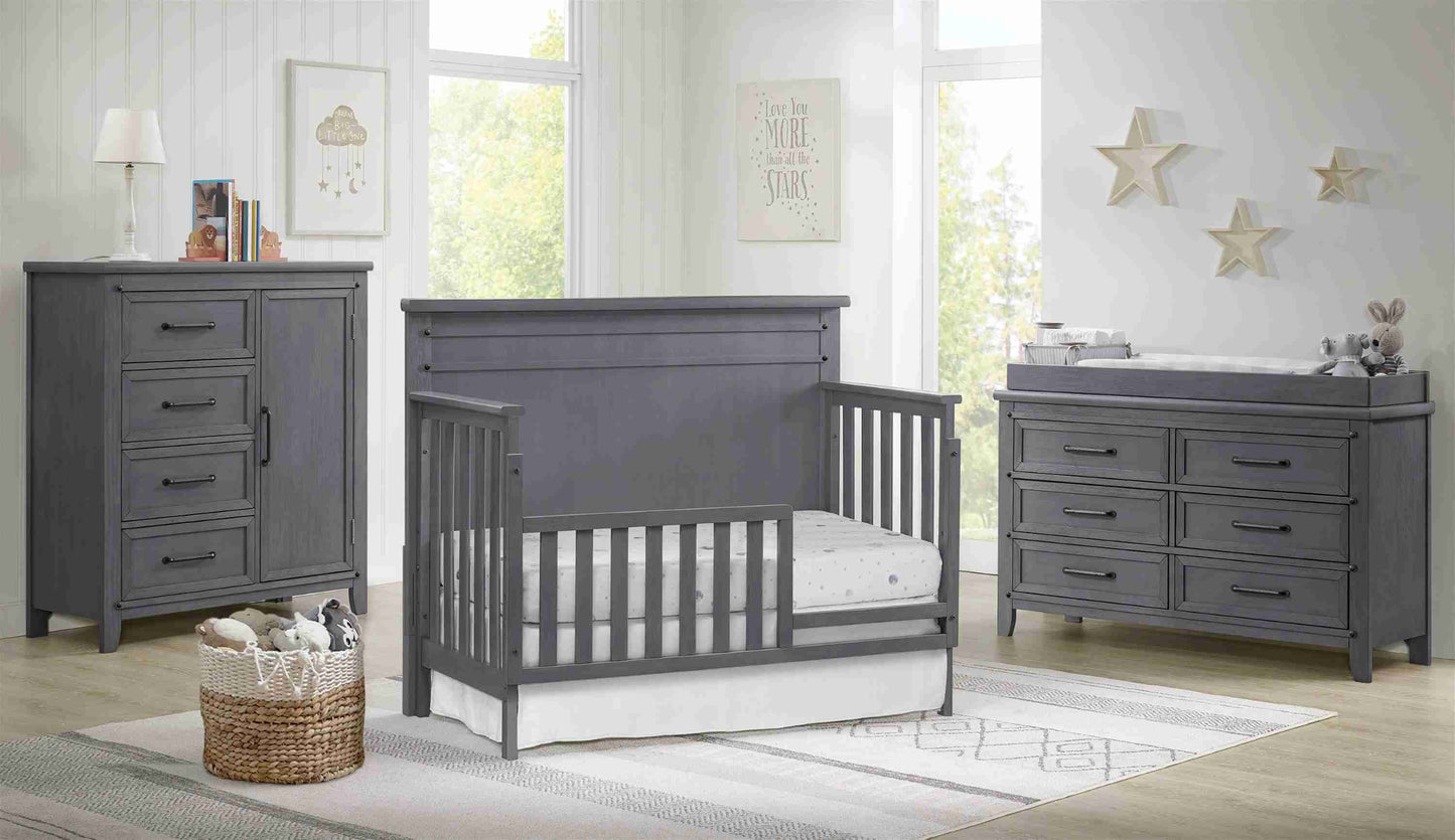 Ellison Guard Rail - Lifestyle Image Inclined Side View of Ellison Convertible Crib with Guard Rail Gray