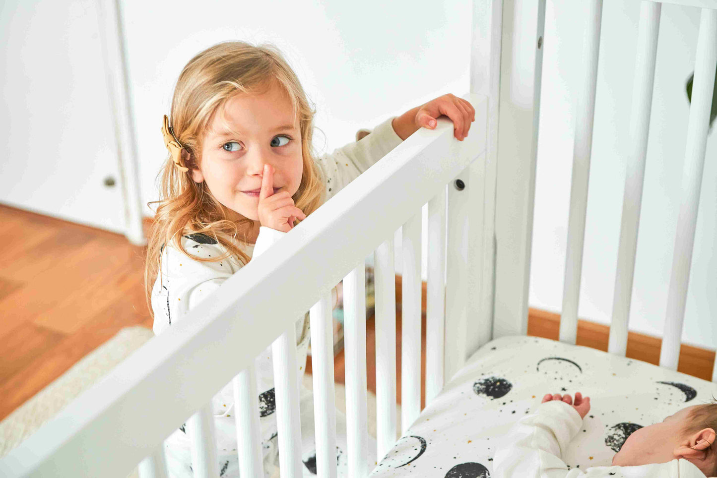 True Highback 4 in 1 Convertible Crib - Zoomed View Lifestyle Image of Highback 4 in 1 Convertible Crib Snowstrom with Baby Sleeping