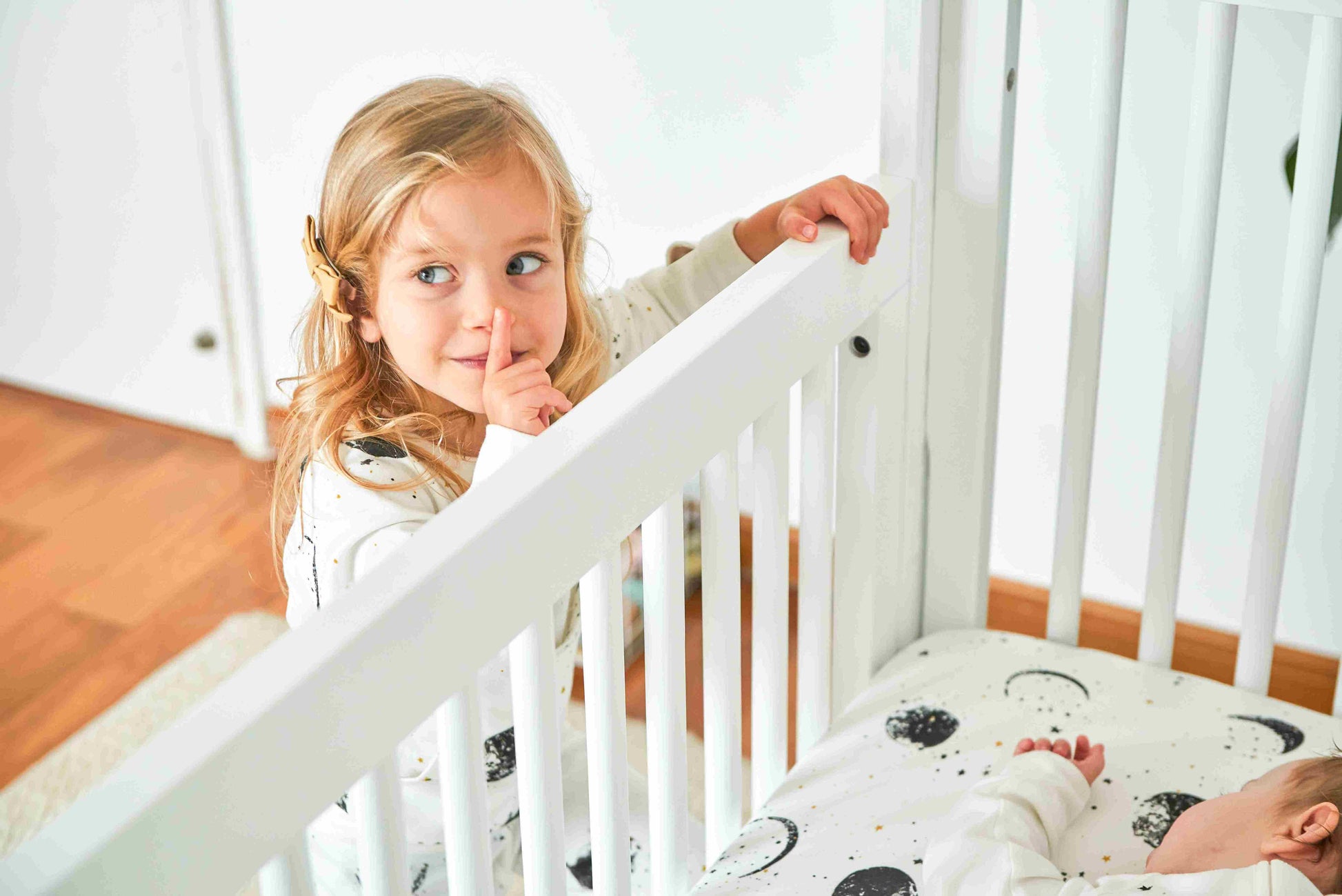 True Highback 4 in 1 Convertible Crib - Zoomed View Lifestyle Image of Highback 4 in 1 Convertible Crib Snowstrom with Baby Sleeping