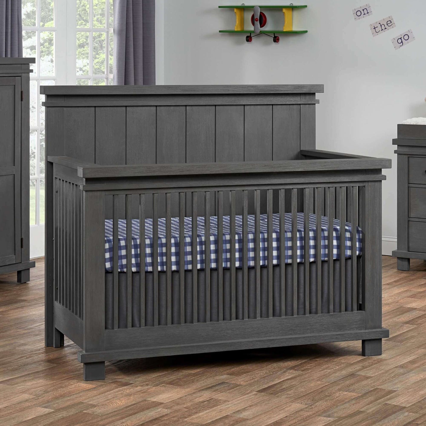 Hampton 4 In 1 Convertible Crib - Lifestyle Image Inclined Side View of Hampton 4 In 1 Convertible Crib Canyon Gray