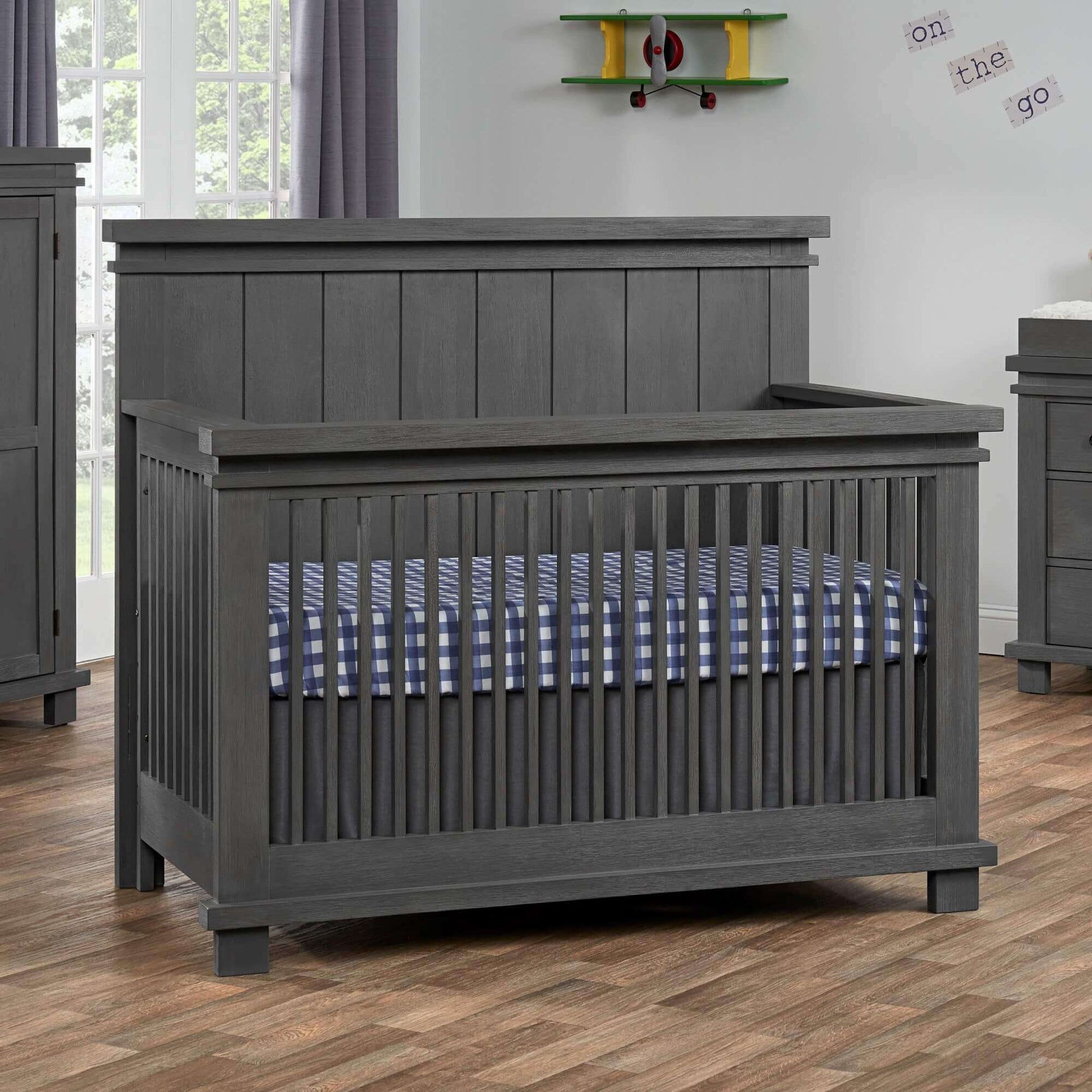 Hampton 4 In 1 Convertible Crib - Lifestyle Image Inclined Side View of Hampton 4 In 1 Convertible Crib Canyon Gray