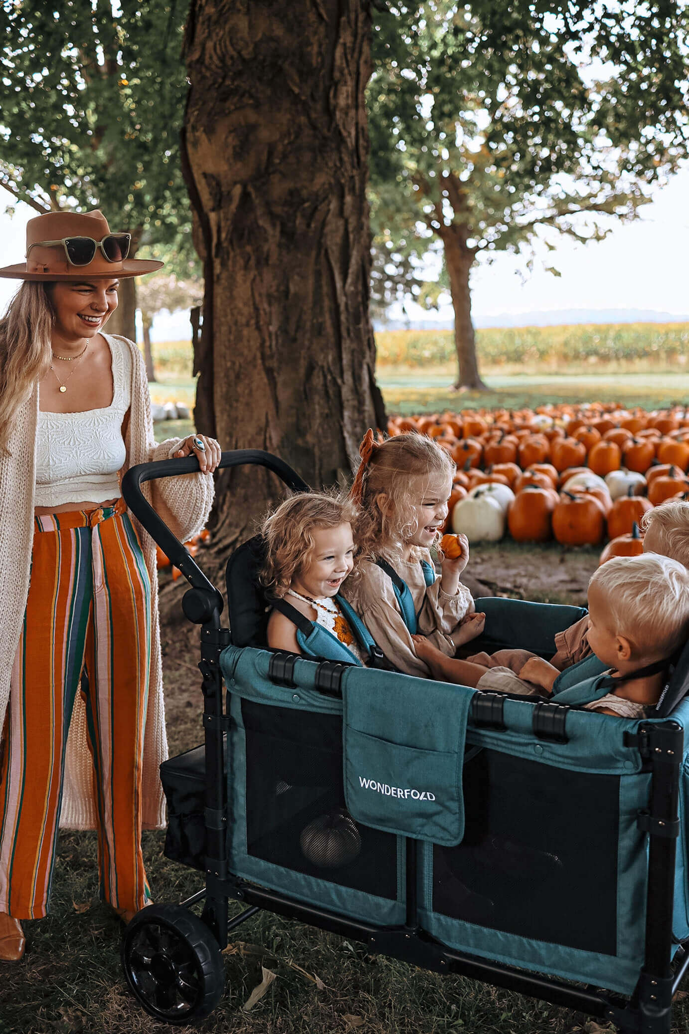 W4 Elite Quad Stroller Wagon - Lifestyle Image of Mother with Toddler's on W4 Elite Quad Stroller Wagon Gray