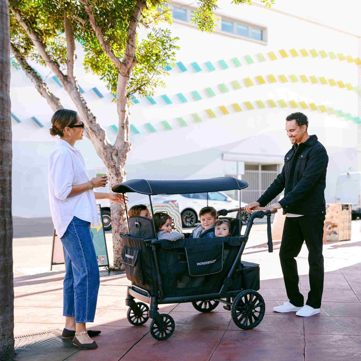 L4 Quad Stroller Wagon - Lifestyle Image of Family Enjoying With Children's on L4 Quad Stroller Wagon Gray