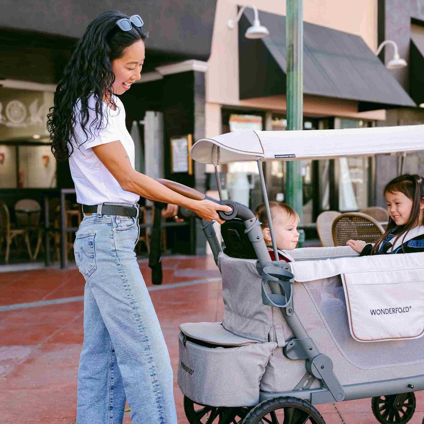 L4 Quad Stroller Wagon - Zoomed Lifestyle Image of Mother With 2 daughter's on L4 Quad Stroller Wagon Gray