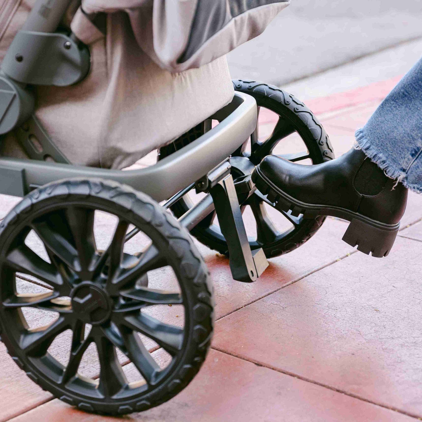 L4 Quad Stroller Wagon - Lifestyle Image of Brake In use of L4 Quad Stroller Wagon Gray