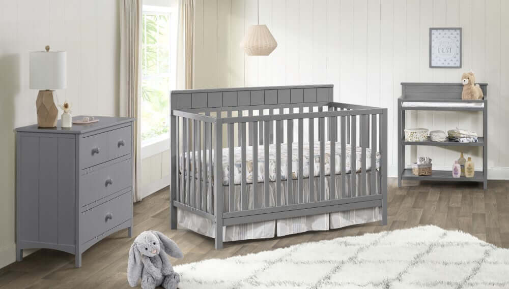 Logan 4-in-1 Convertible Crib - Lifestyle Image Inclined Side View of Logan 4-in-1 Convertible Crib Dove Gray with 3 Drawer Dresser