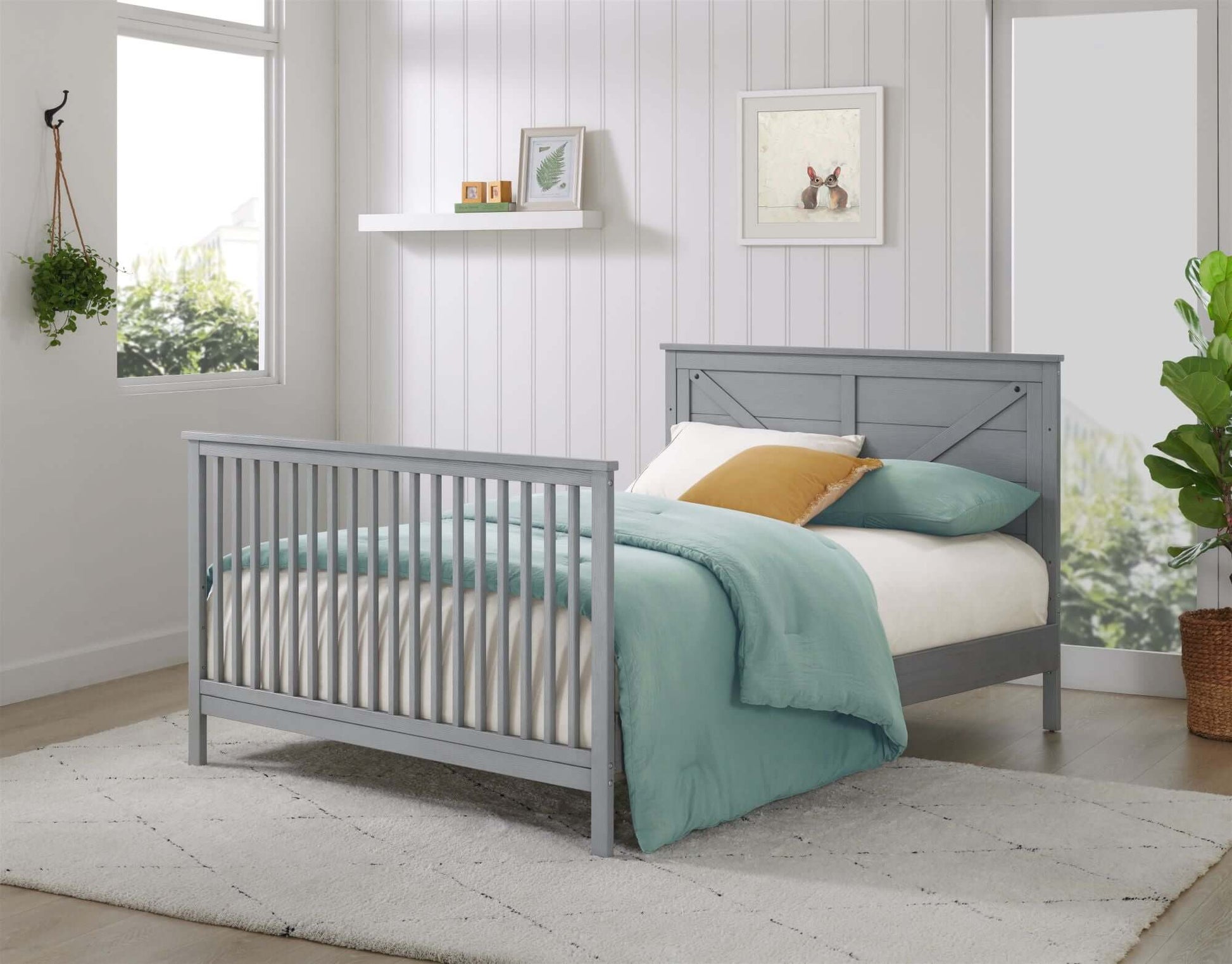 Montauk 4-in-1 Convertible Crib - Lifestyle Image Inclined Side View of Montauk Full Sized Bed Farmhouse Gray