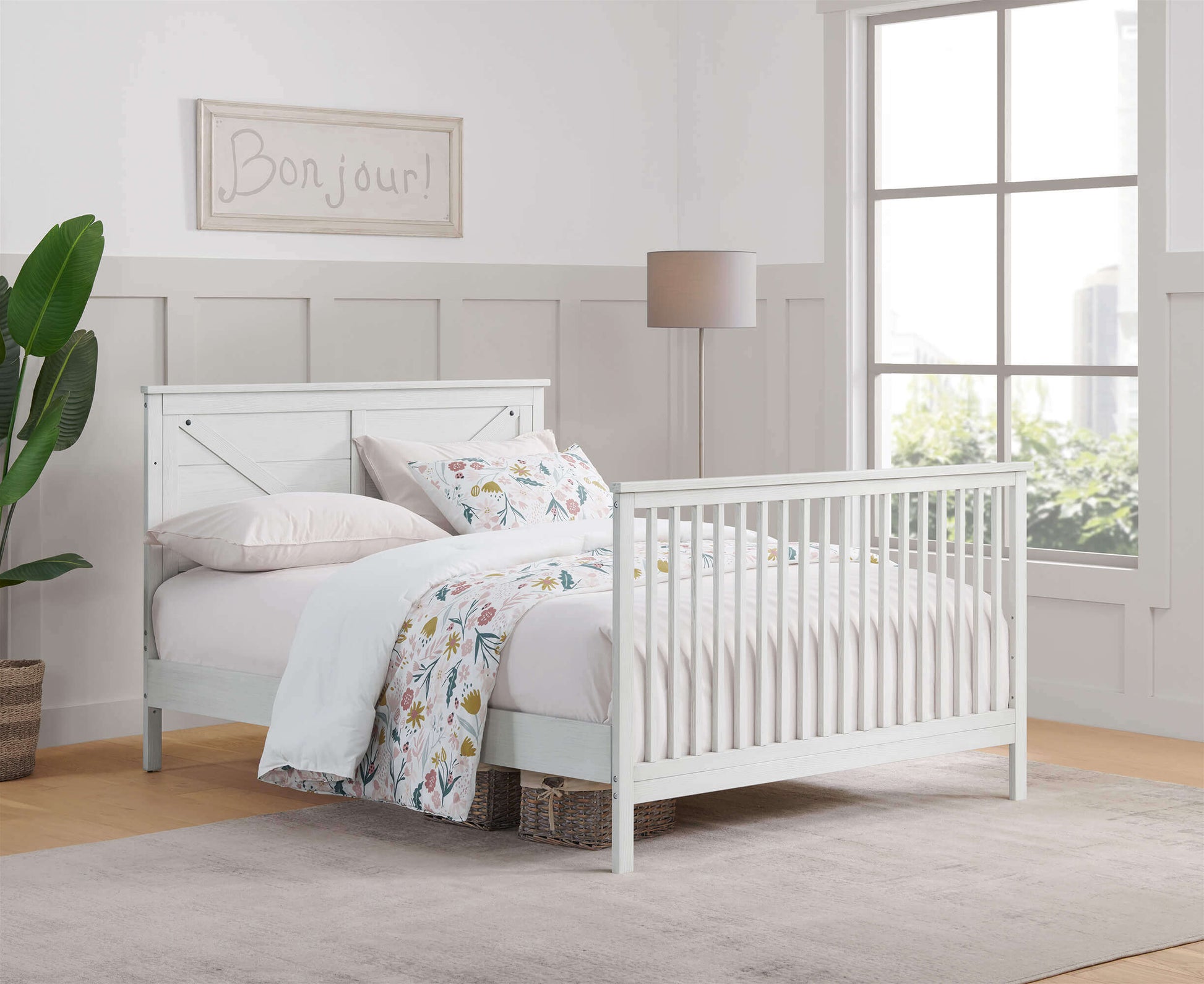 Montauk 4-in-1 Convertible Crib - Lifestyle Image Inclined Side View of Montauk Full Sized Bed Barn White